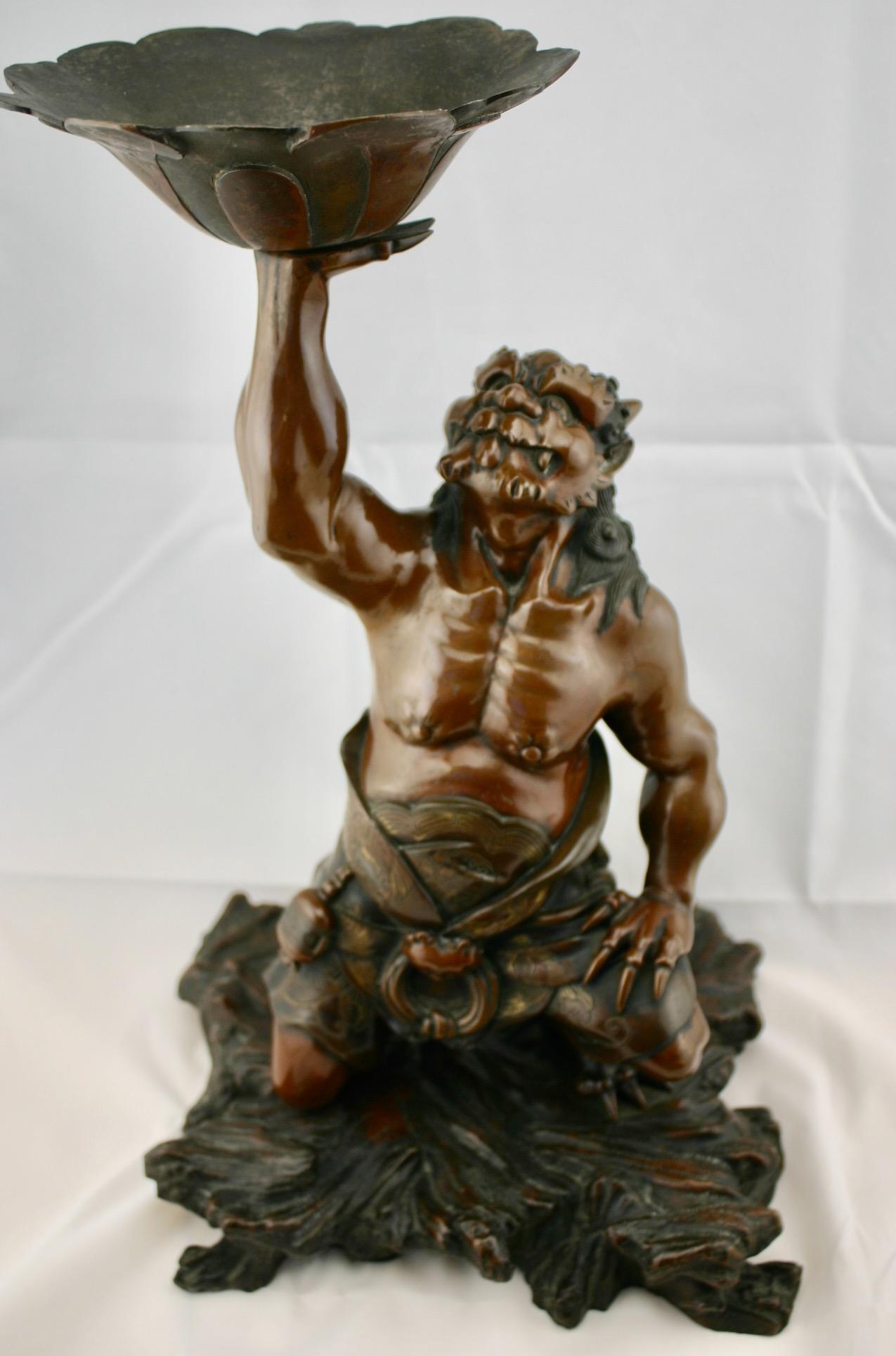 Japanese Meiji period finely cast, patinated and partially gilded figure of Oni holding a lotus flower. Very fine and detailed decoration. No signature located. The figure is 17 1/2