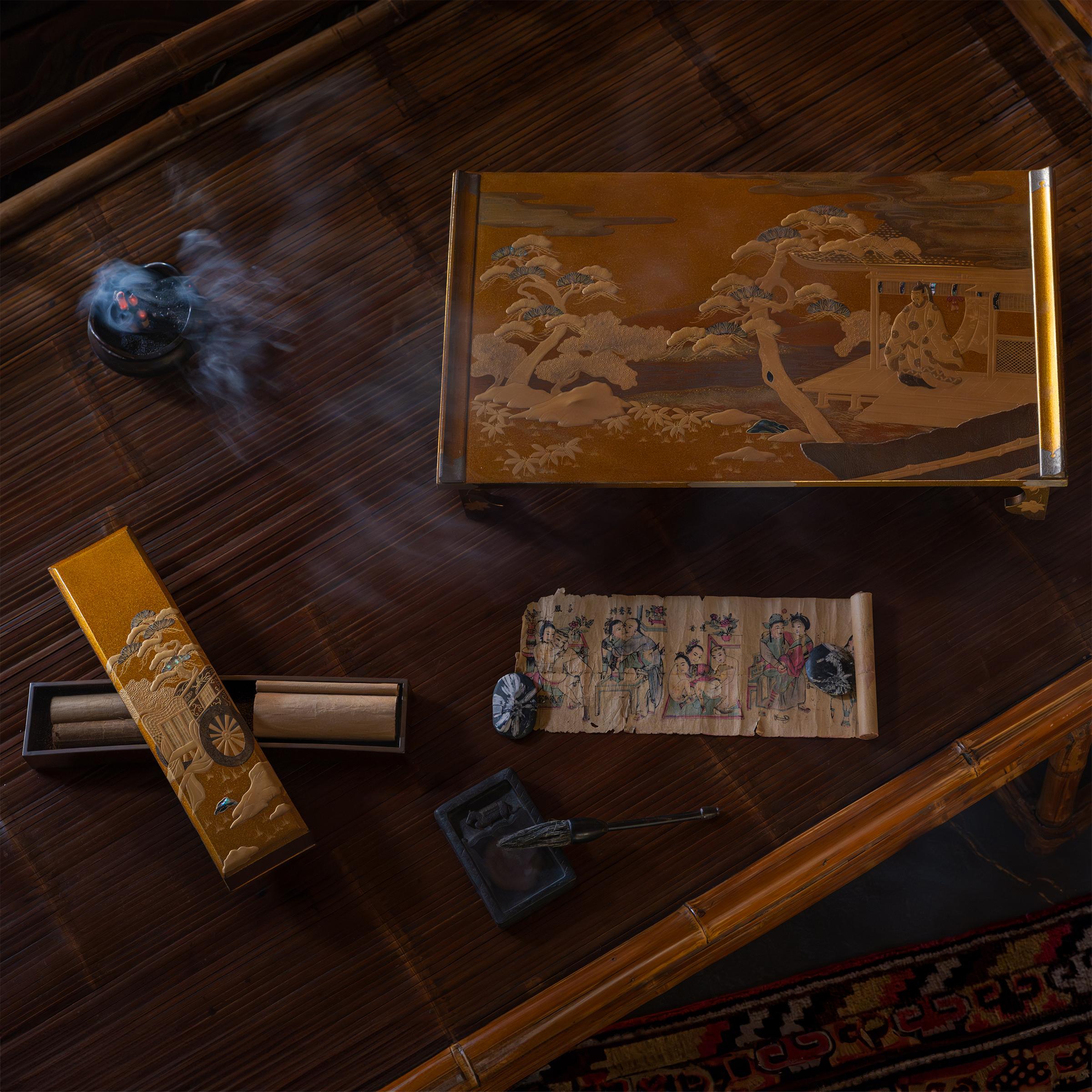 With intricate construction and exquisite decoration, this fine tabletop writing set is a masterpiece of Japanese lacquerware. The matching set includes a writing table (bundai) and poem box (tanzaku bako), both decorated with gilt lacquer in the