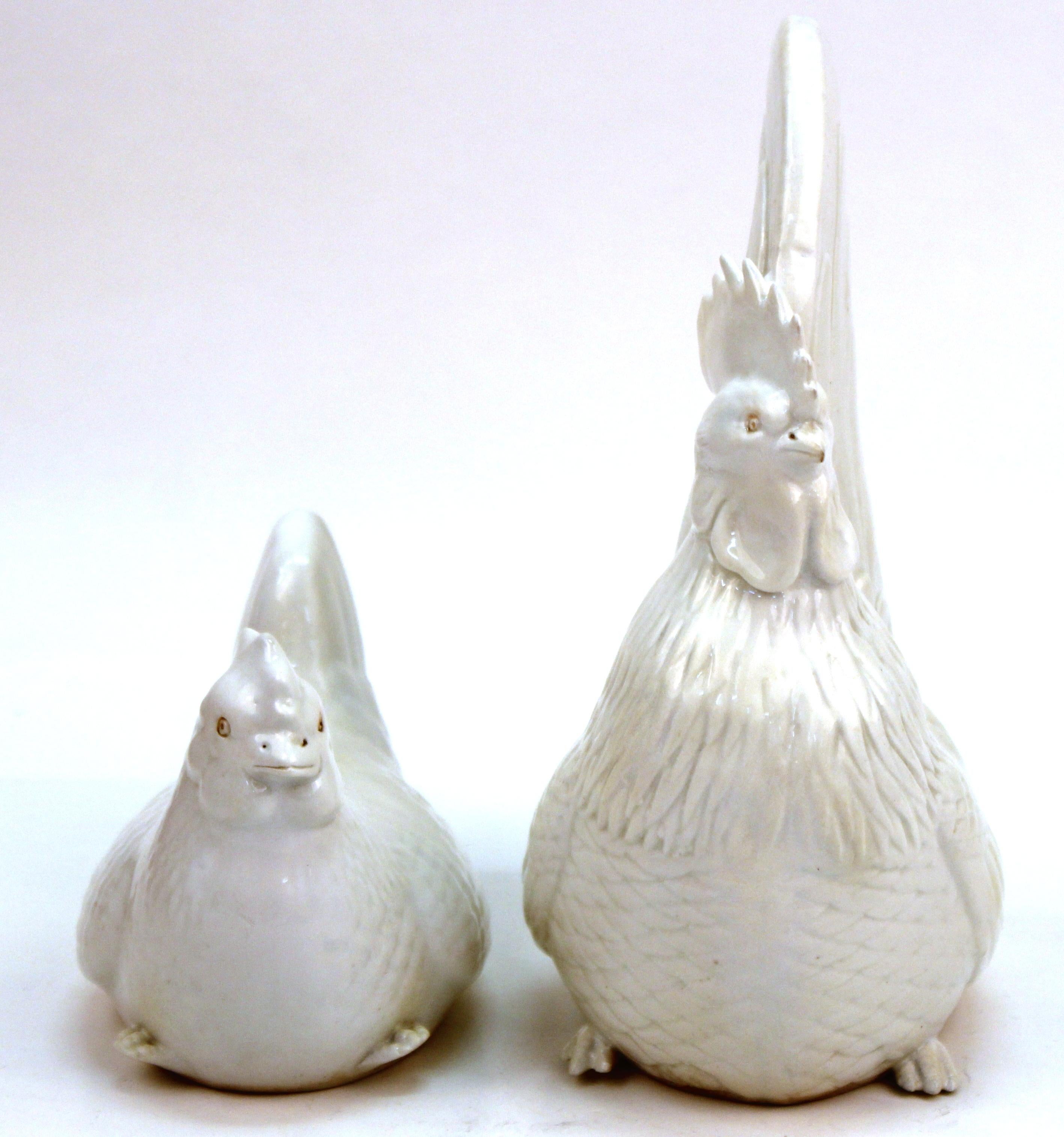 Japanese Meiji period pair of rooster and hen, made by Hirado in white-glazed porcelain, with bisque eyes. The pair was made in Japan in circa 1890 and features realistic details. In great antique condition with age-appropriate wear and