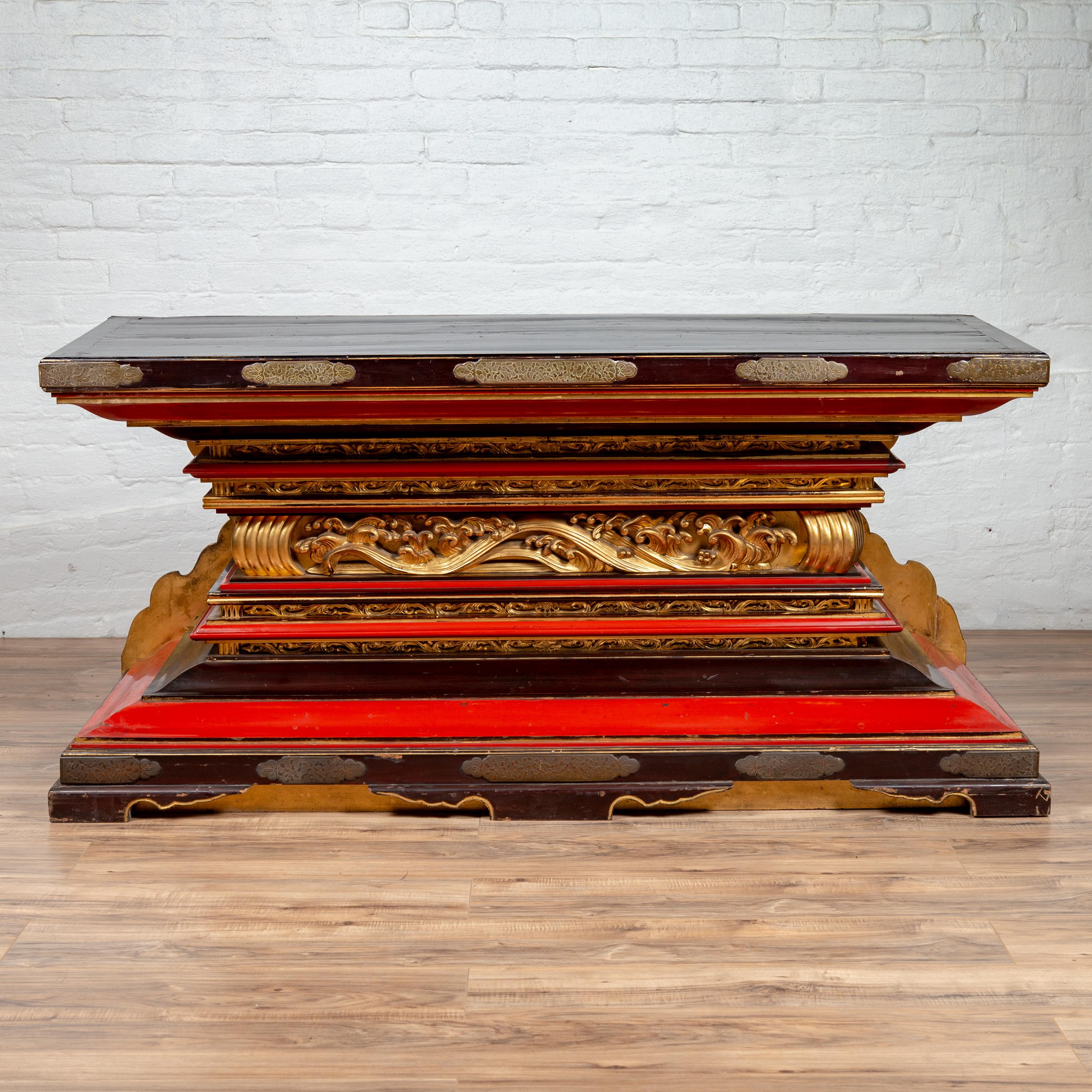 An antique Meiji period Japanese all lacquered altar shrine console table base from the late 19th century with black, red and gold highlights. Born in Japan in the late 1800s during the Meiji period, this altar shrine table base was used for