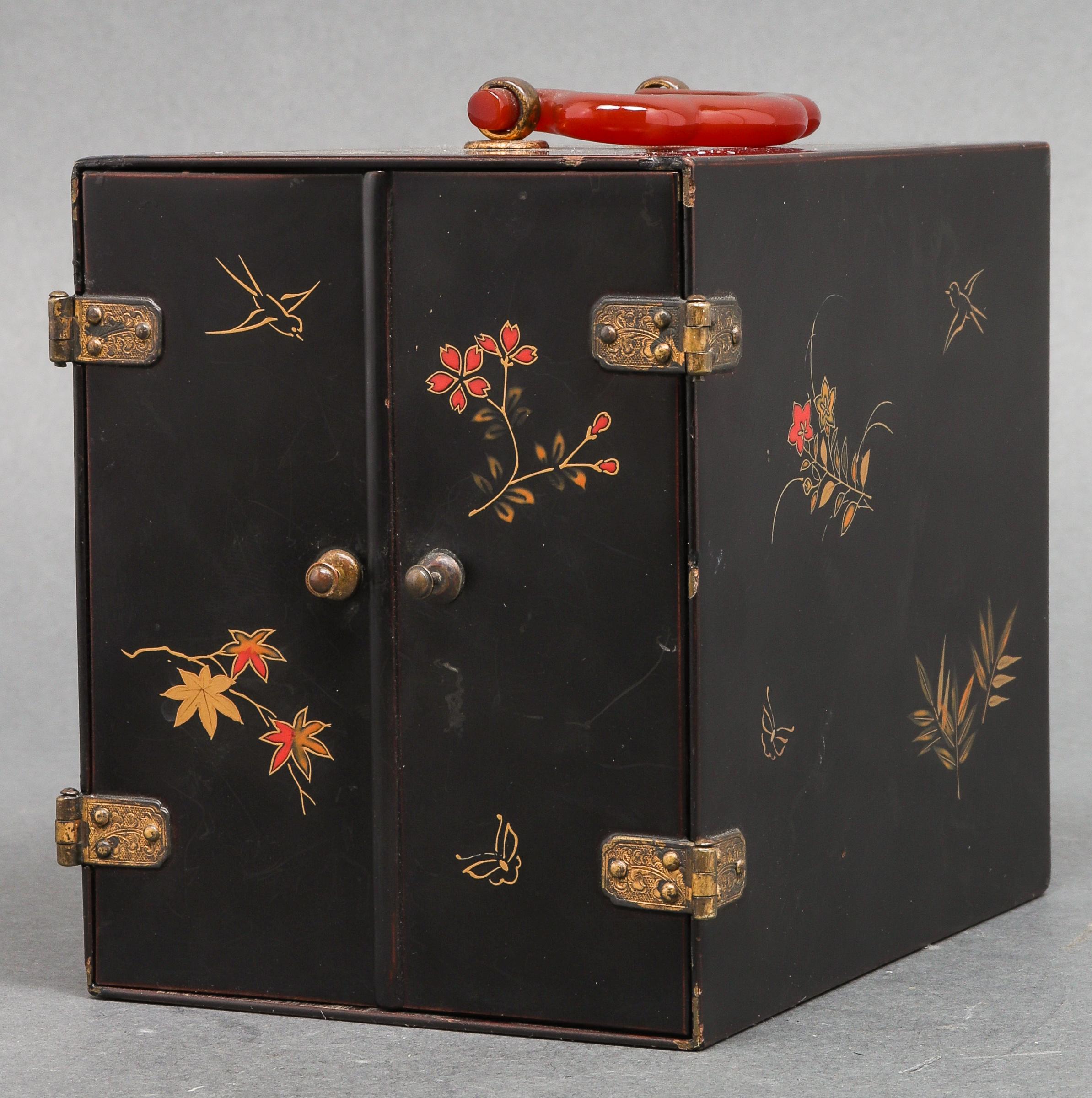 Japanese painted and lacquered wood jewelry cabinet form box, with brass mounted doors opening to reveal internal three-drawer chest, with a carnelian handle atop. Measures: 4.5