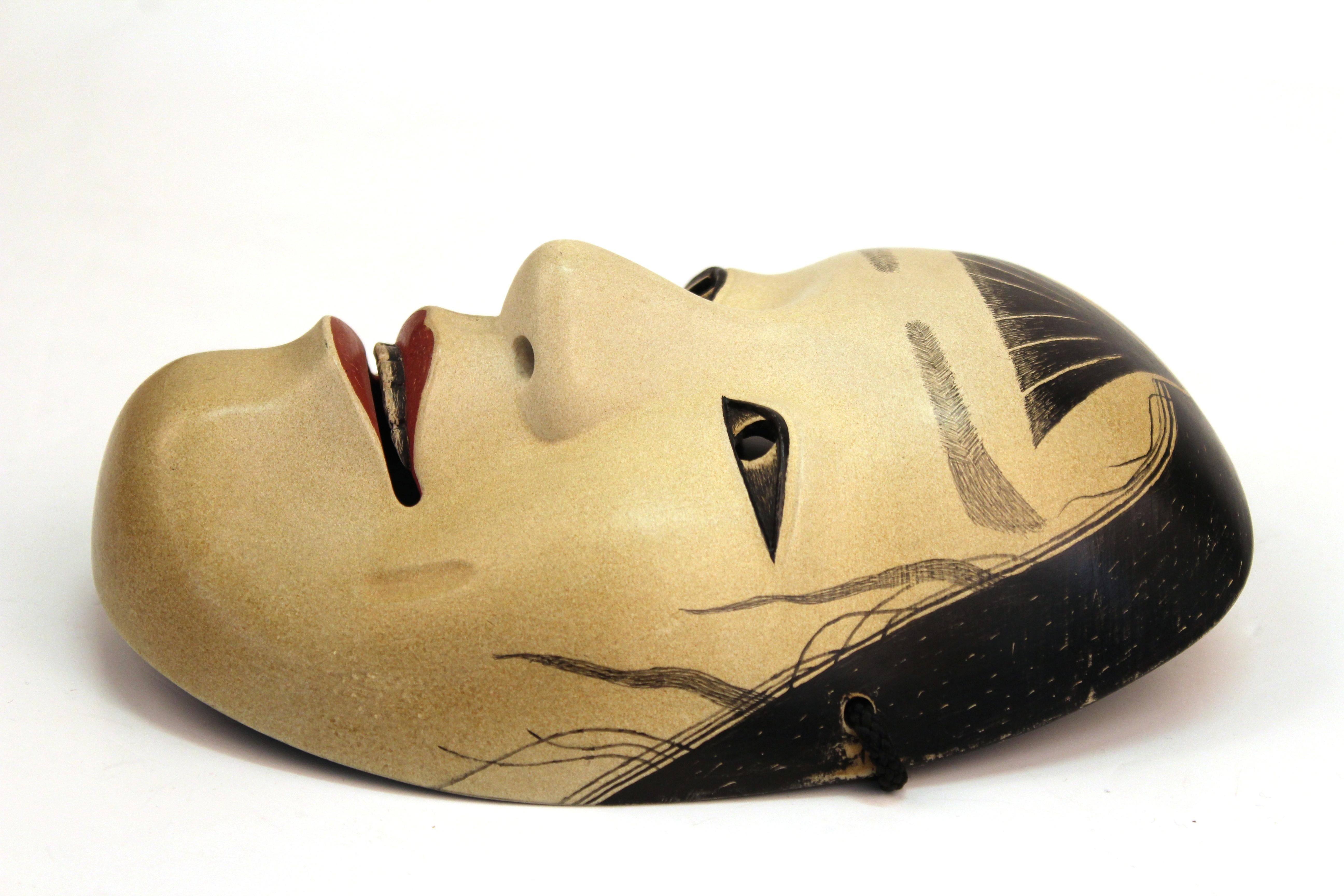 Japanese early Meiji period Noh theater mask made of carved wood with gofun layers. The piece was made in Japan in circa 1880 and is signed on the back. In great antique condition with age-appropriate wear and use.