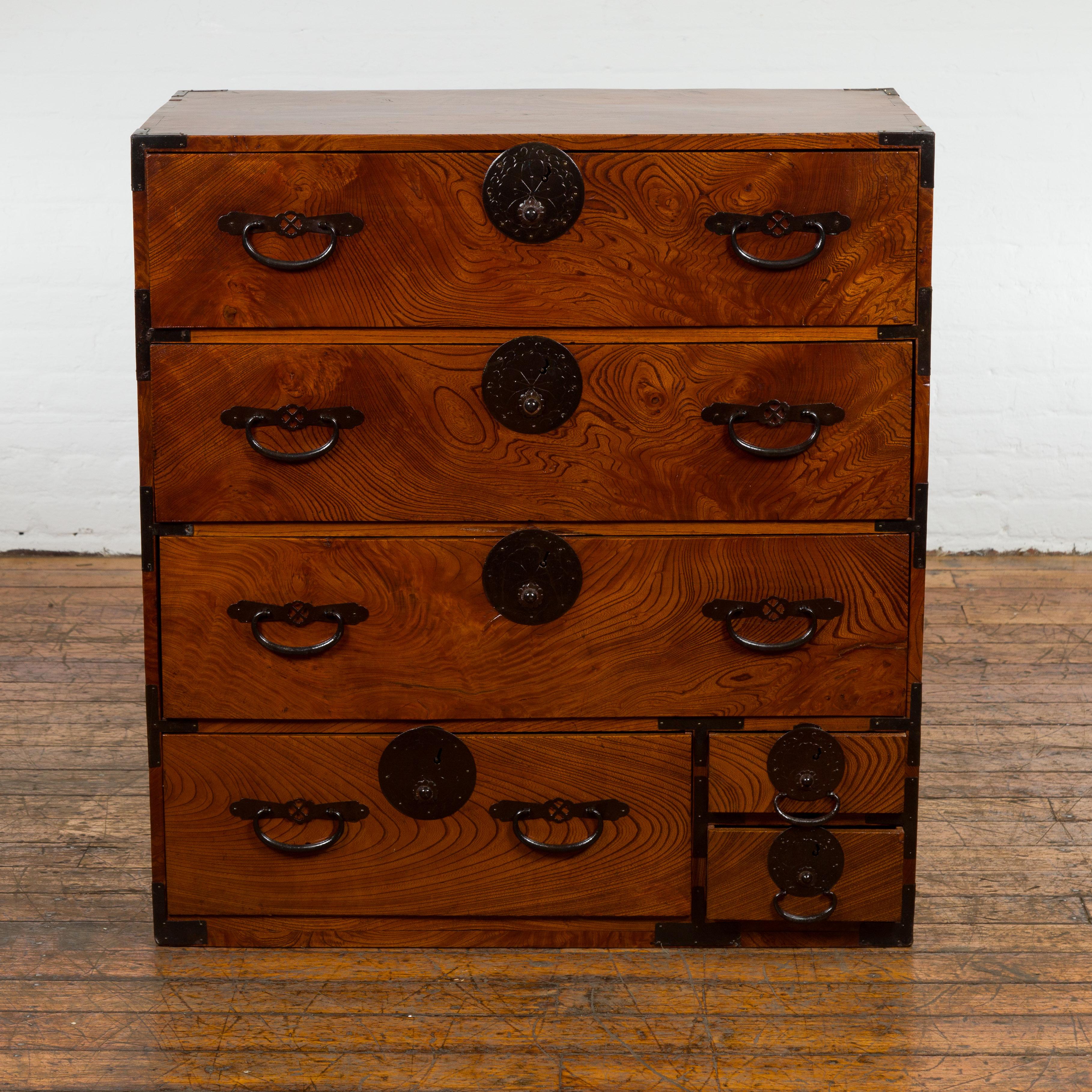 A Japanese Meiji period Isho Dansu clothing chest from the 19th century, with six drawers, iron hardware and professionally refreshed brown lacquer. Created in Japan during the Meiji period in the 19th century, this Isho Dansu clothing chest