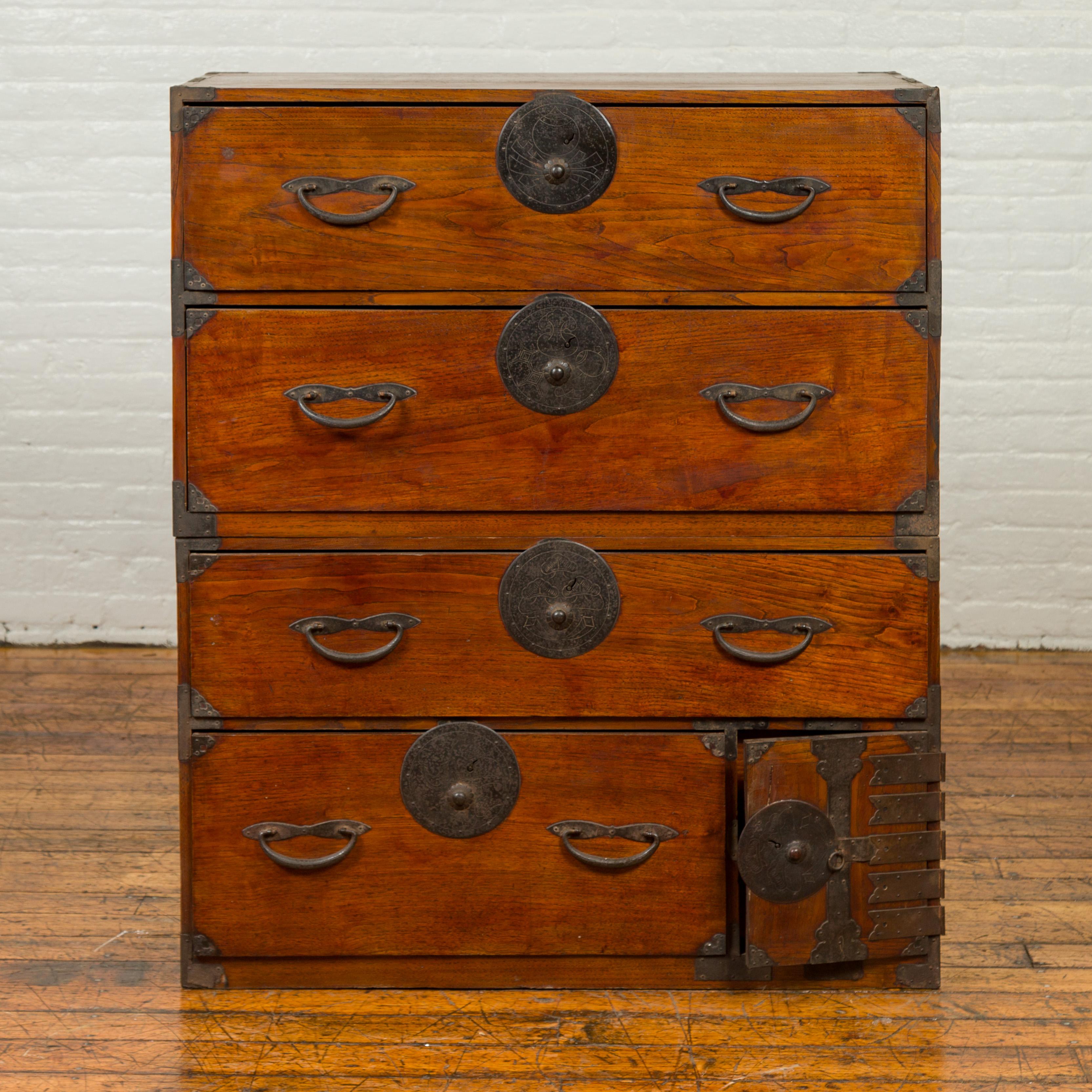 A Japanese Meiji period keyaki wood tansu clothing chest in the Sendai Isho-dansu style, with hand-cut iron hardware, drawers and safe. Born during the 19th century, this wooden tansu is a fine example of Japan's traditional mobile cabinetry.