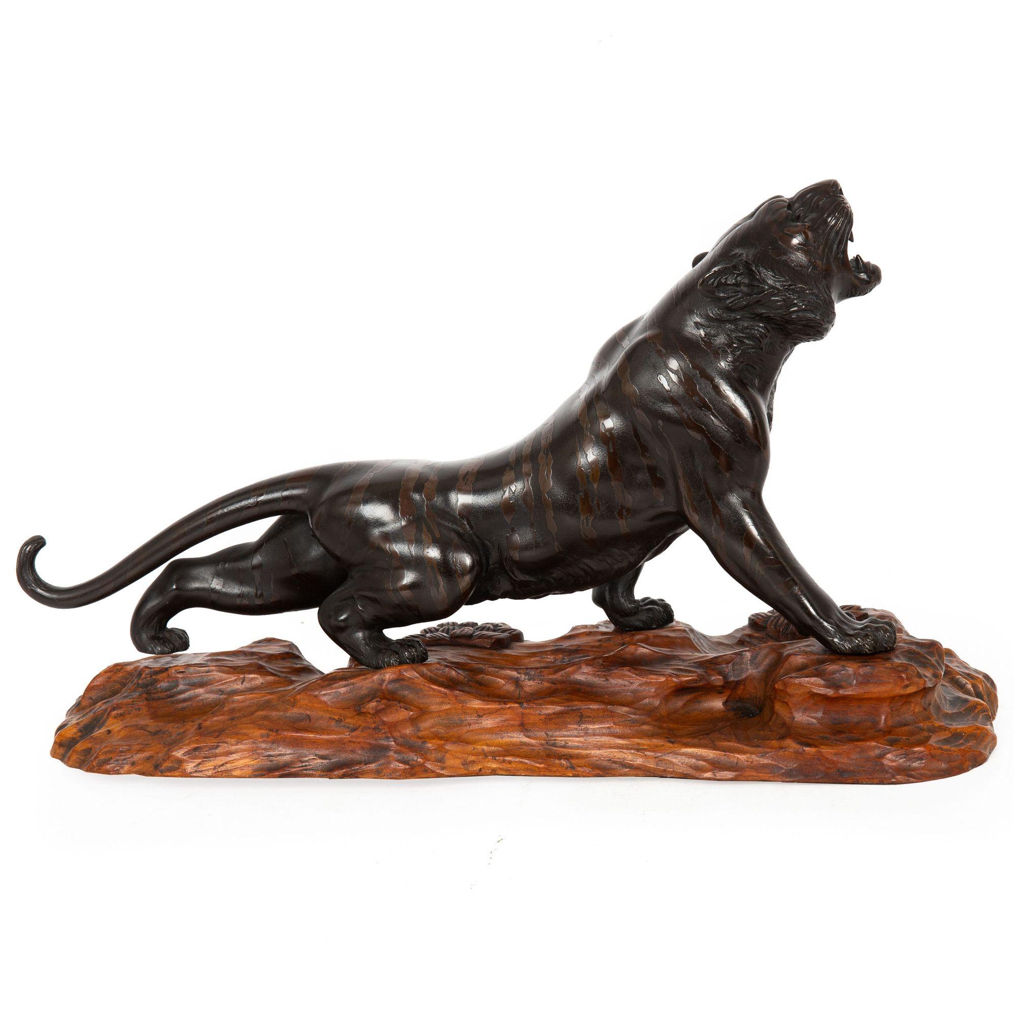 OKIMONO OF A ROARING TIGER OVER A WOODEN BASE
Japan, Meiji Period  Patinated bronze  signed Mitani to underside of belly

Item # 302LOC16P 

This remarkable Japanese bronze okimono of a Roaring Tiger from the Meiji period exemplifies exceptional