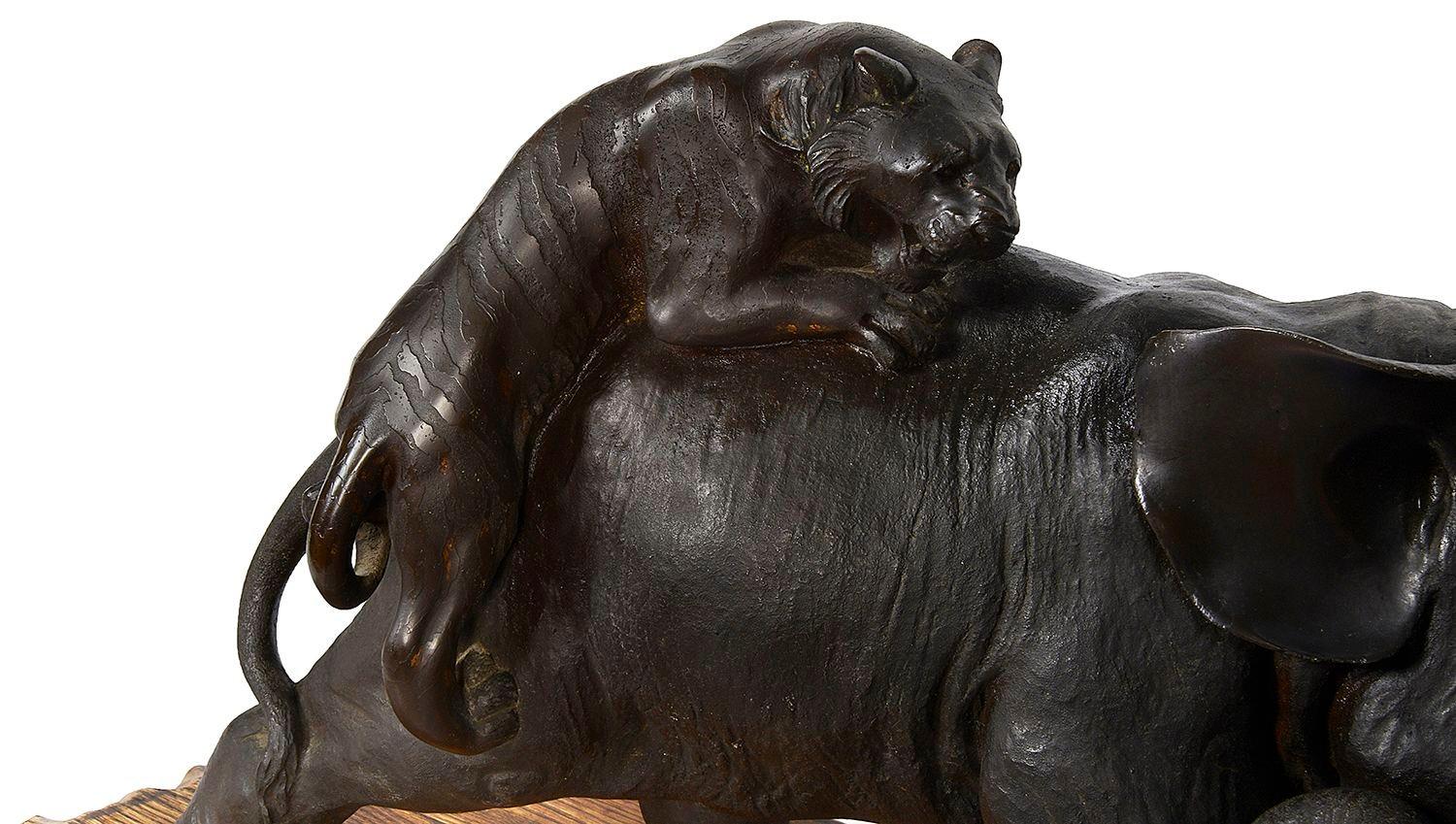 Patinated Japanese Meiji period bronze Elephant fighting two Lions. For Sale