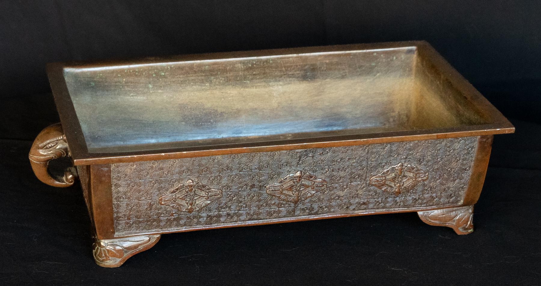 Japanese Meiji Period Bronze Incense Holder / Jardiniere. A substantial incense holder in the Chinese Ming style. Sides and bottom covered in a relief decoration overall., with a warm natural bronze patina. Raised on shaped corner bracket feet with