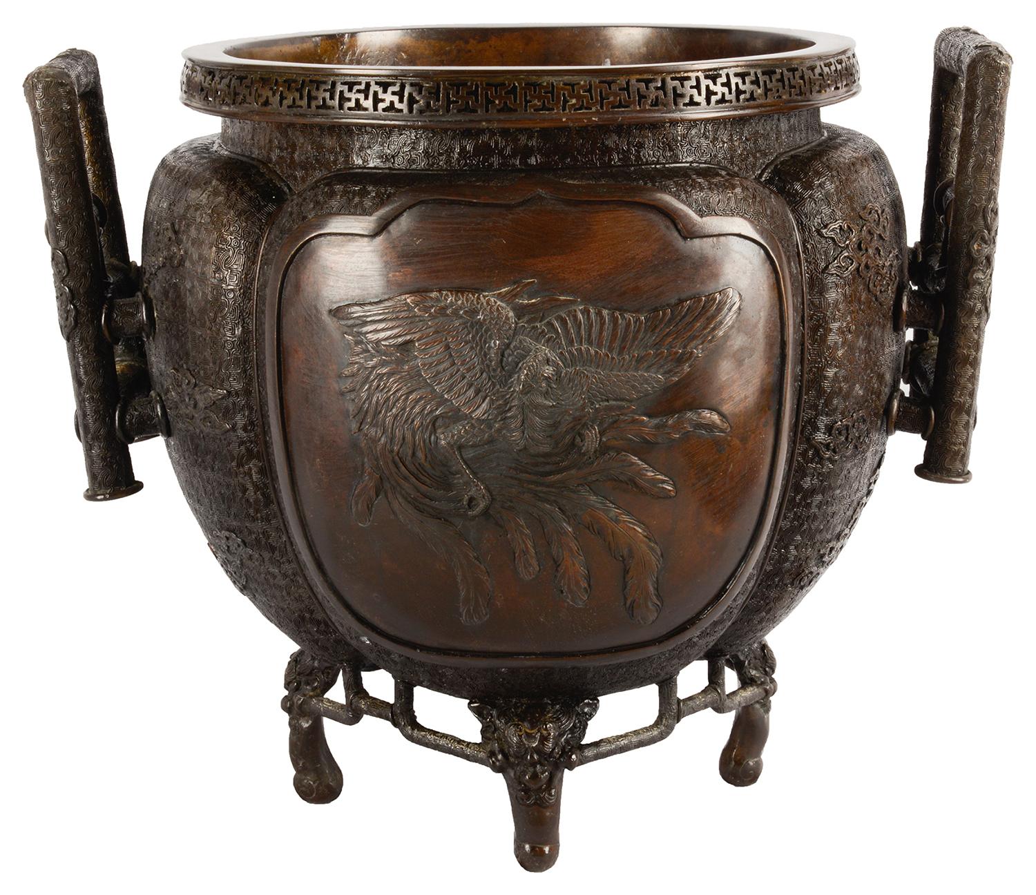 A very good quality 19th century, Meiji period (1868-1912) Bronze two handled jardiniere, having wonderful engraved and embossed classical motifs and inset panels depicting mythical dragon and bird like creatures. Measures: 40cm (16