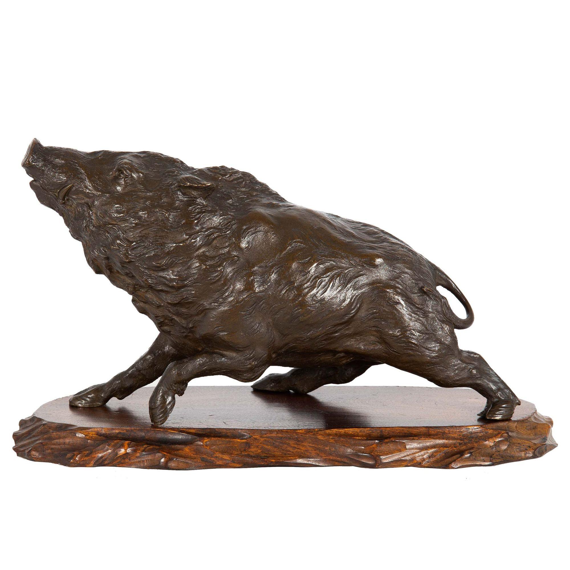 OKIMONO OF A WILD BOAR
Japan, Meiji Period  Patinated bronze over carved hardwood base  Signed 