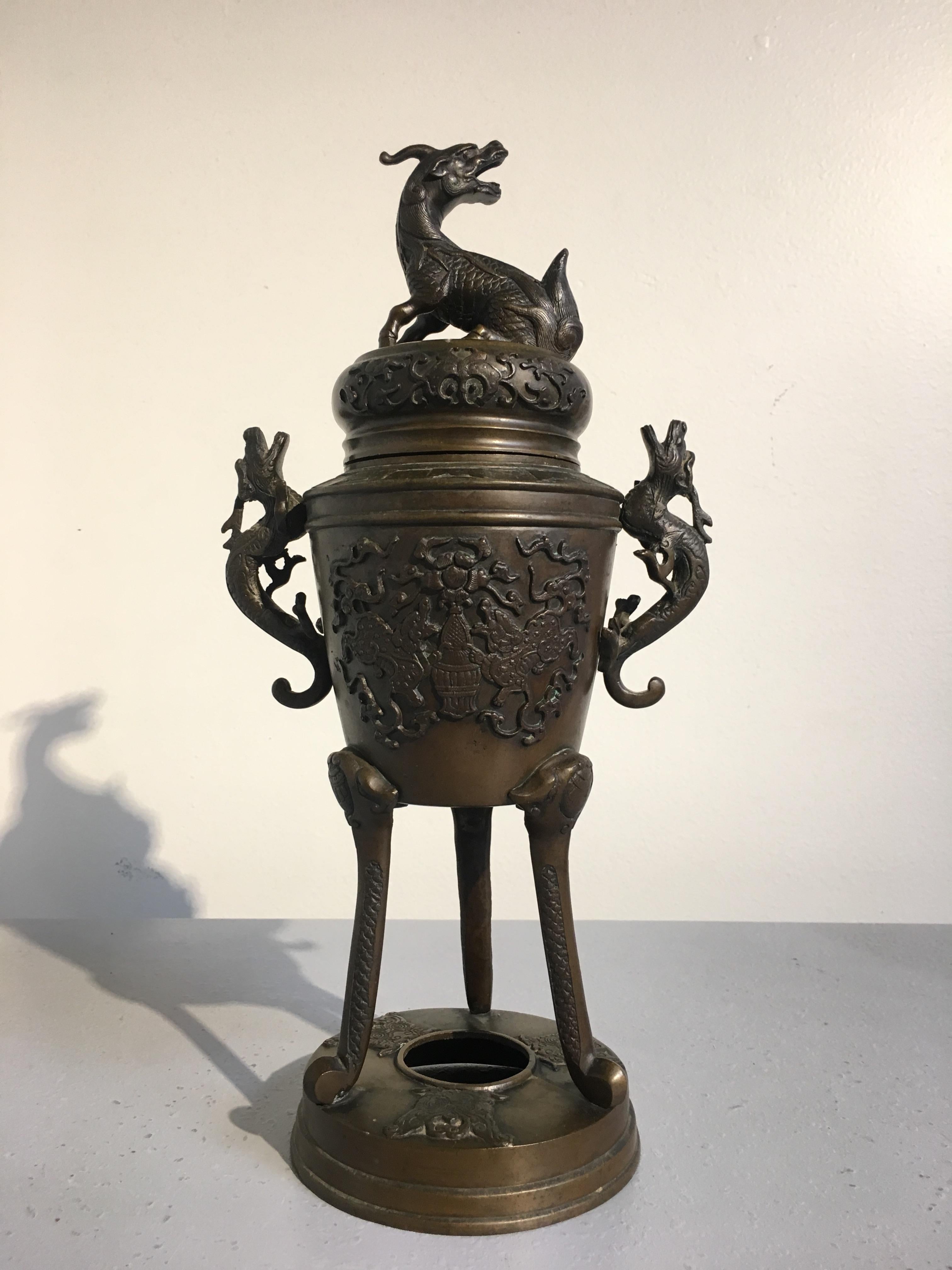 A lovely Japanese bronze koro, incense burner, Meiji Period, circa 1900. 

The tapered body of the incense burner sits upon three tall, slender legs rising from a circular stand. The body cast with a design of a pair of kirin surrounding a