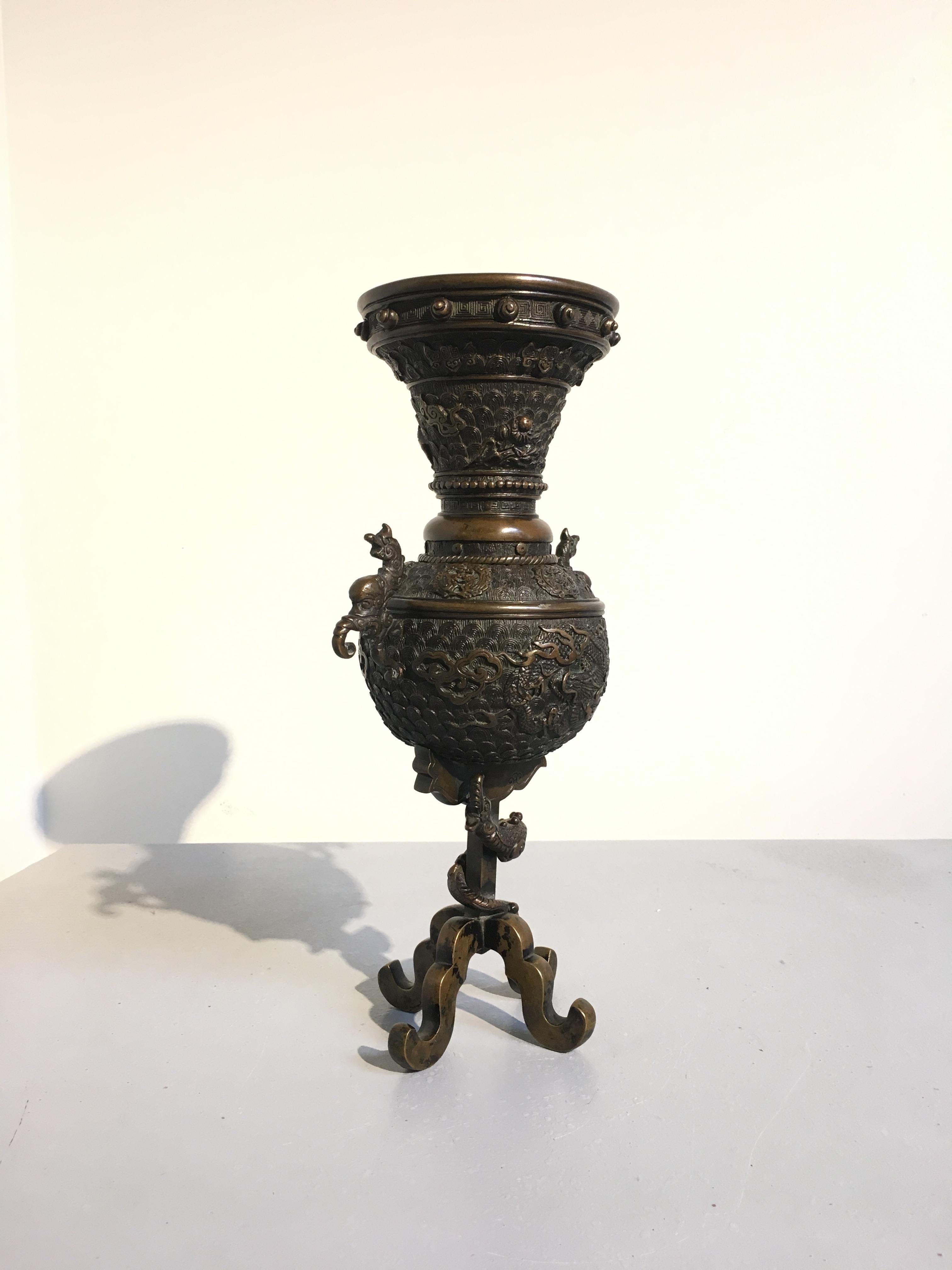 An exuberantly cast Japanese bronze vessel for ikebana flower arranging, called an usubata, Meiji Period, late 19th century. 

The vessel comprised of two parts. The neck detaches to allow easier access to interior of the vase. The body of the