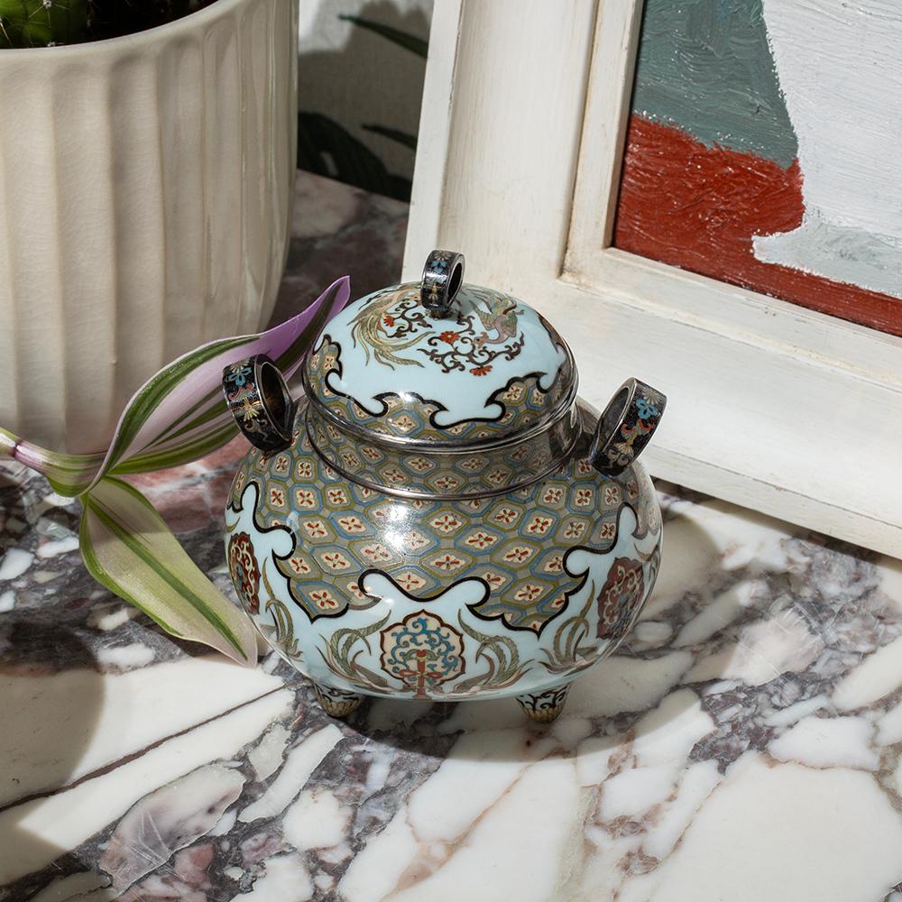 Silver Mounted

From our Japanese collection, we are thrilled to offer this Japanese Cloisonne Enamel Koro by Tsukamoto Hikokichi. The Cloisonne Enamel Koro of exceptional quality shaped in bulbous squat form with three looped handles and removable
