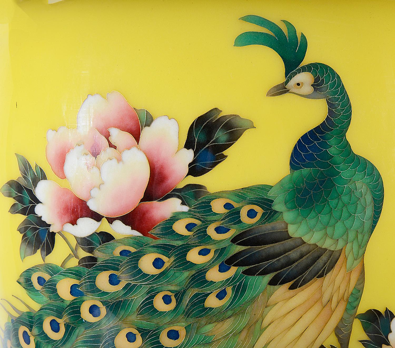 A fine quality Japanese enamel vase from the Ando Cloisonne studio with this beautiful yellow ground with and exotic peacock among pink flowers on a rock. early 20th Century. (Showa period)