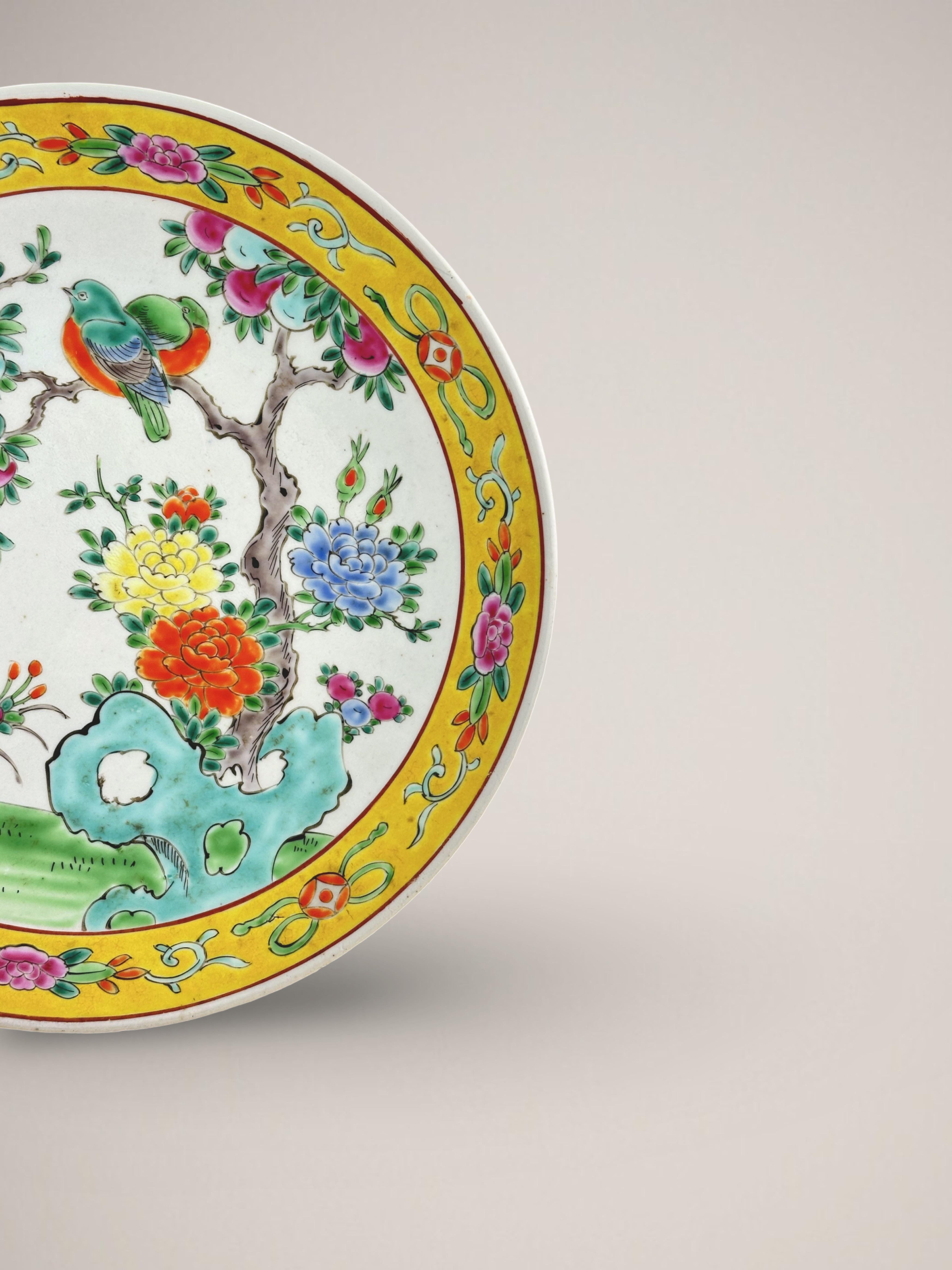 A brightly coloured Famille Jaune porcelain charger plate. Handcrafted in Japan around the end of the nineteenth century, during the Meiji era.

The large decorative plate depicts a brightly coloured figural scene, conveying a sense of springtime