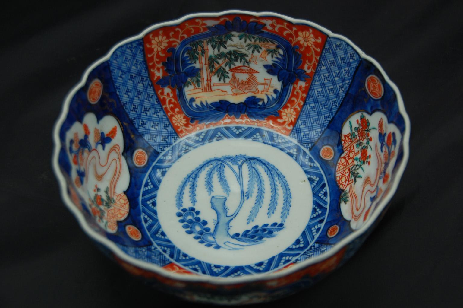 Japanese 19th century Meiji period Imari 7 1/2 inch scalloped bowl with Classic underglaze blue and overglaze iron red with touches of green and highlights in gold decoration. The central weeping willow motif shows the rebirth of life with a new