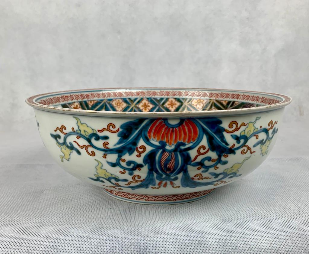 Hand decorated Japanese Meiji period porcelain bowl. The interior hand painted scene depicts three birds sitting on the limb of a tree. The reverse is hand painted with underglaze blue and over painted with iron red, yellow and gold enamels. The