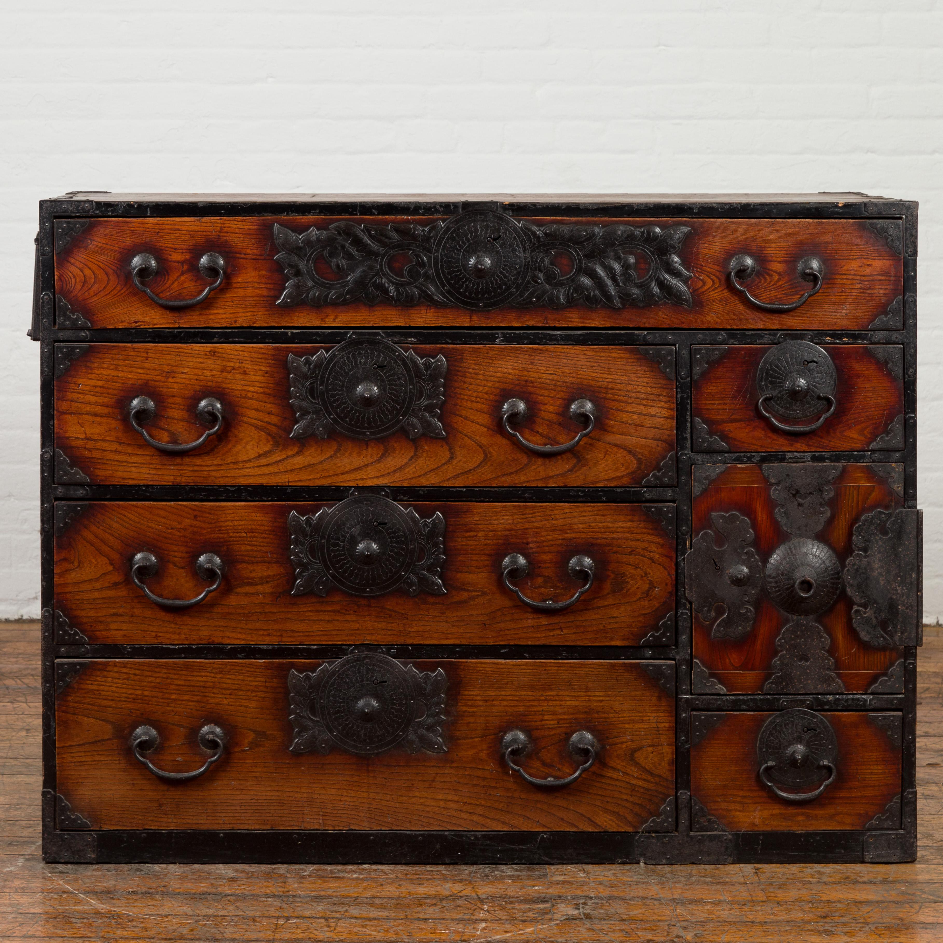 A Japanese Meiji period keyaki wood Sendai tansu clothing chest from the late 19th century, with hand-cut iron hardware and safe box. Created in the Sendai Prefecture during the last quarter of the 19th century, this keyaki (elm) wood tansu is a