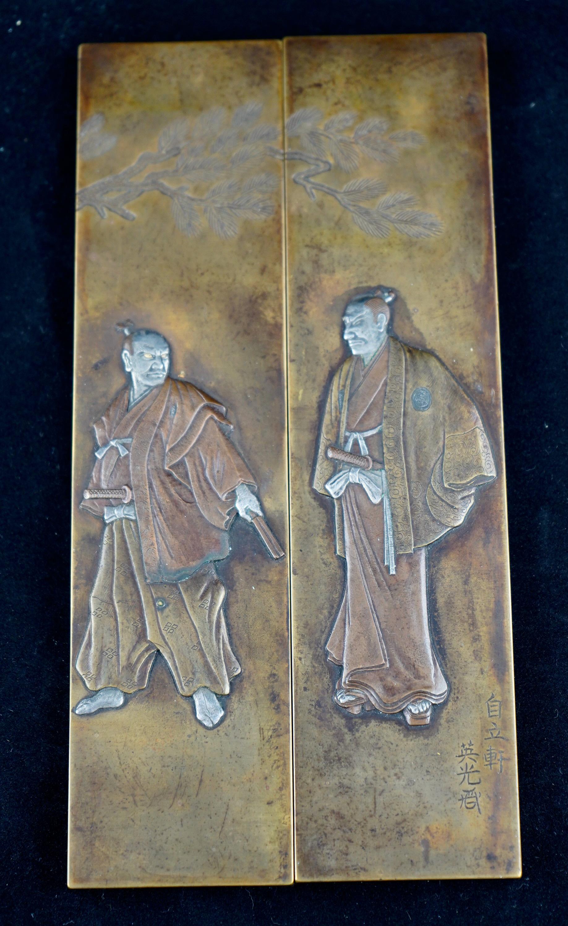 Japanese Meiji period fine pair of scroll weights decorated with shakudo and silver samurai figures. The weights fill solid and heavy. One of the weights has Japanese writing ( see images).