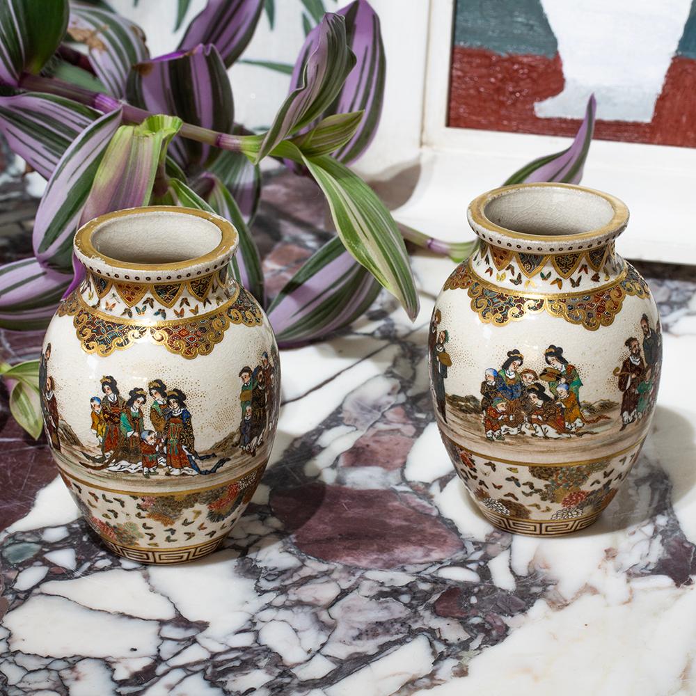 Painted with Continuous Scenes

From our Japanese collection, we are delighted to offer this Japanese Satsuma Vase Pair by Gyokuzan. The vases of squat bulbous form with pinched neck and slightly flared rim. The vases decorated with a top border of
