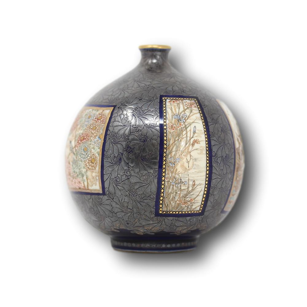 Japanese Meiji period globular bottle vase. The vase of extremely rare form with small opening and a tight pinched neck with a large globular body upon a raised foot rim. Decorated extensively with scrolling on-laid silver around 5 scenes featuring