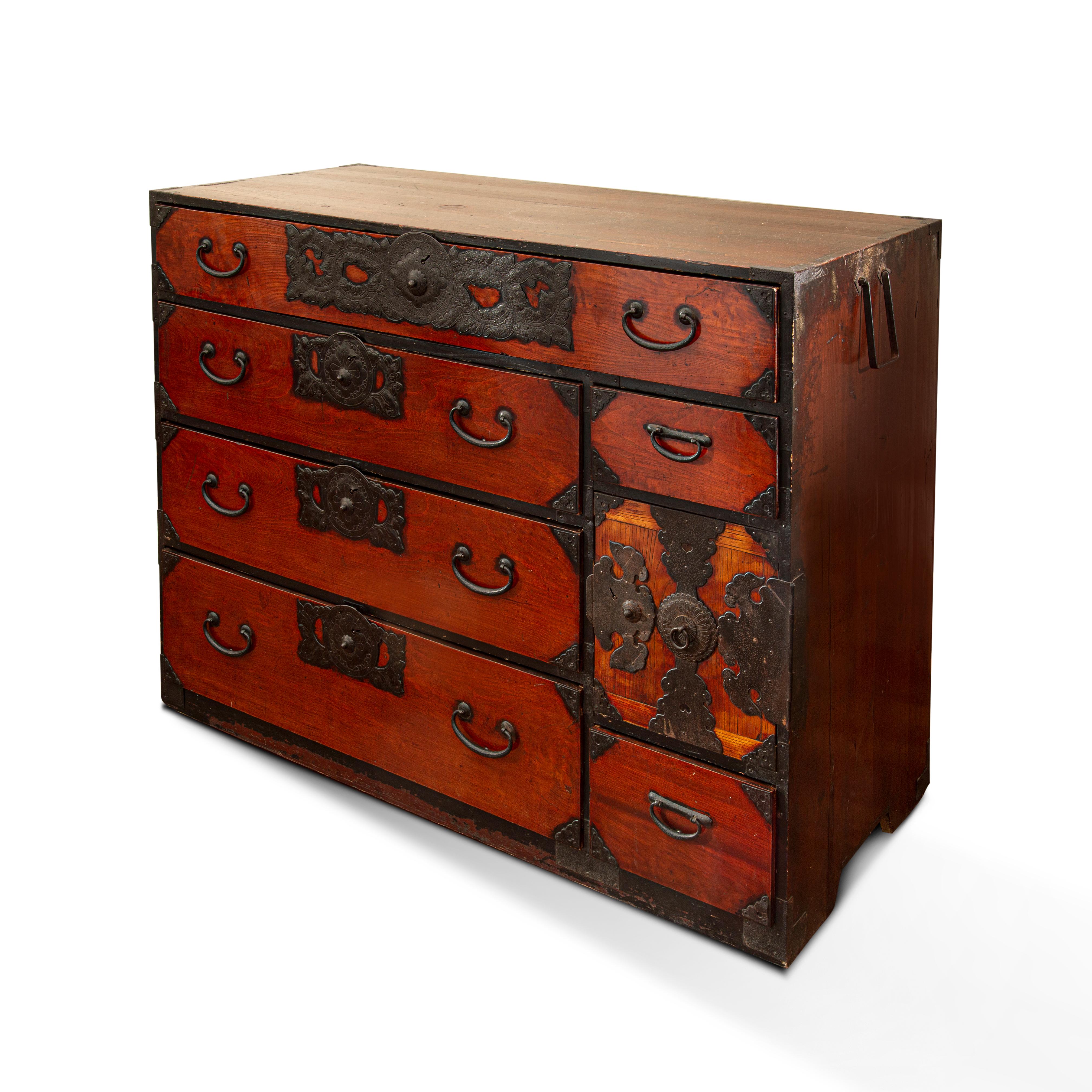 This 19th-century Japanese Tansu clothing chest produced in the Meiji period is made of Japanese cedar wood (cryptomeria Japonica) in its inner parts, while for the outer parts it is made of Keyaki wood, (Ulmacea), complemented by hand-cut iron
