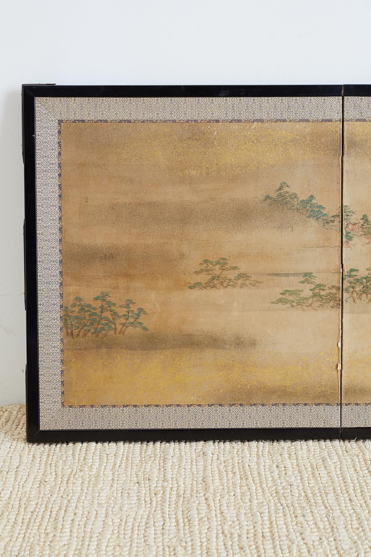 Diminutive Japanese late Meiji period two-panel landscape screen. Featuring a small village with pagoda roofs hidden in green pine trees. The scene is decorated with gilt specks on top and bottom. Probably cut down from a larger screen at some point