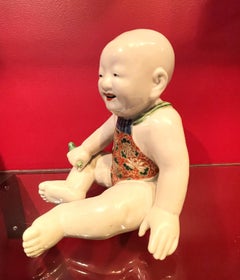 Japanese Meiji Porcelain Figurine of Boy Holding a Green Whistle Bird, Ca. 1890