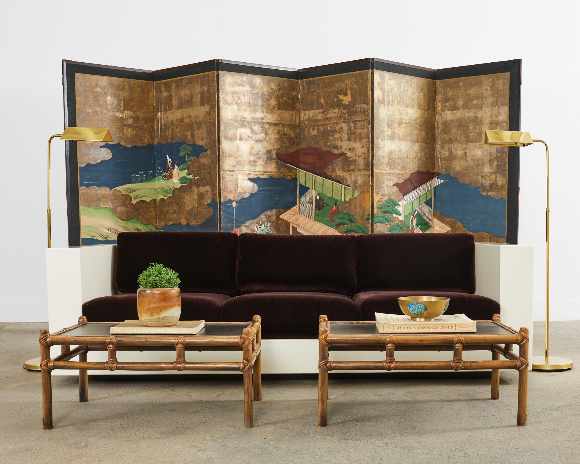 Large early 20th century Japanese late Meiji period six-panel folding byobu screen depicting episodes from the tale of Genji. The scenes include butterfly dancers and third princess with her cat. Beautifully crafted with gold leaf squares and