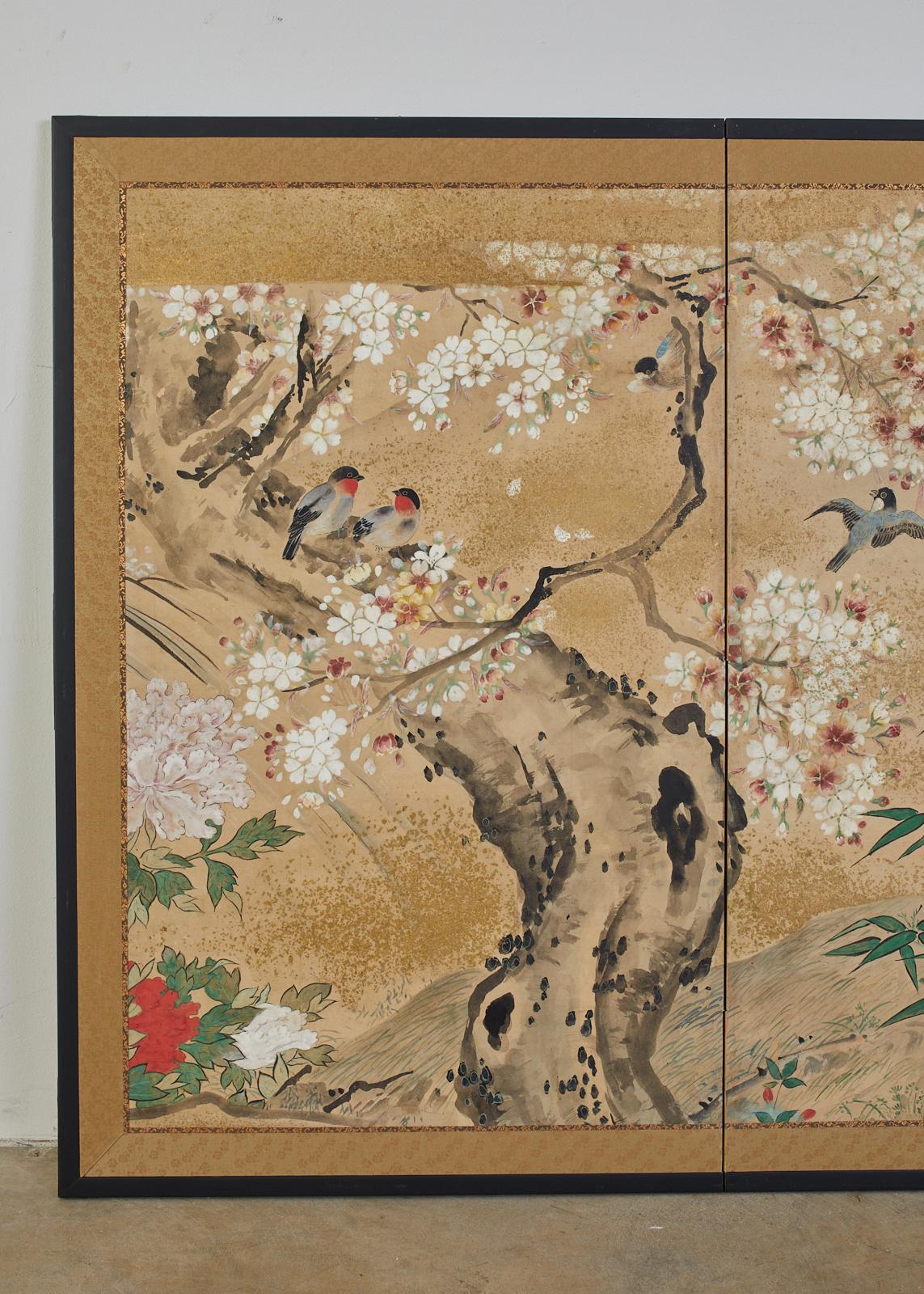 Exceptional Japanese Meiji period two-panel screen, circa 1900. Featuring songbirds amid sakura cherry trees and flowering peony. Made in the Nihonga School style on handcrafted mulberry paper. Ink and natural pigments with gold flecks decorate the