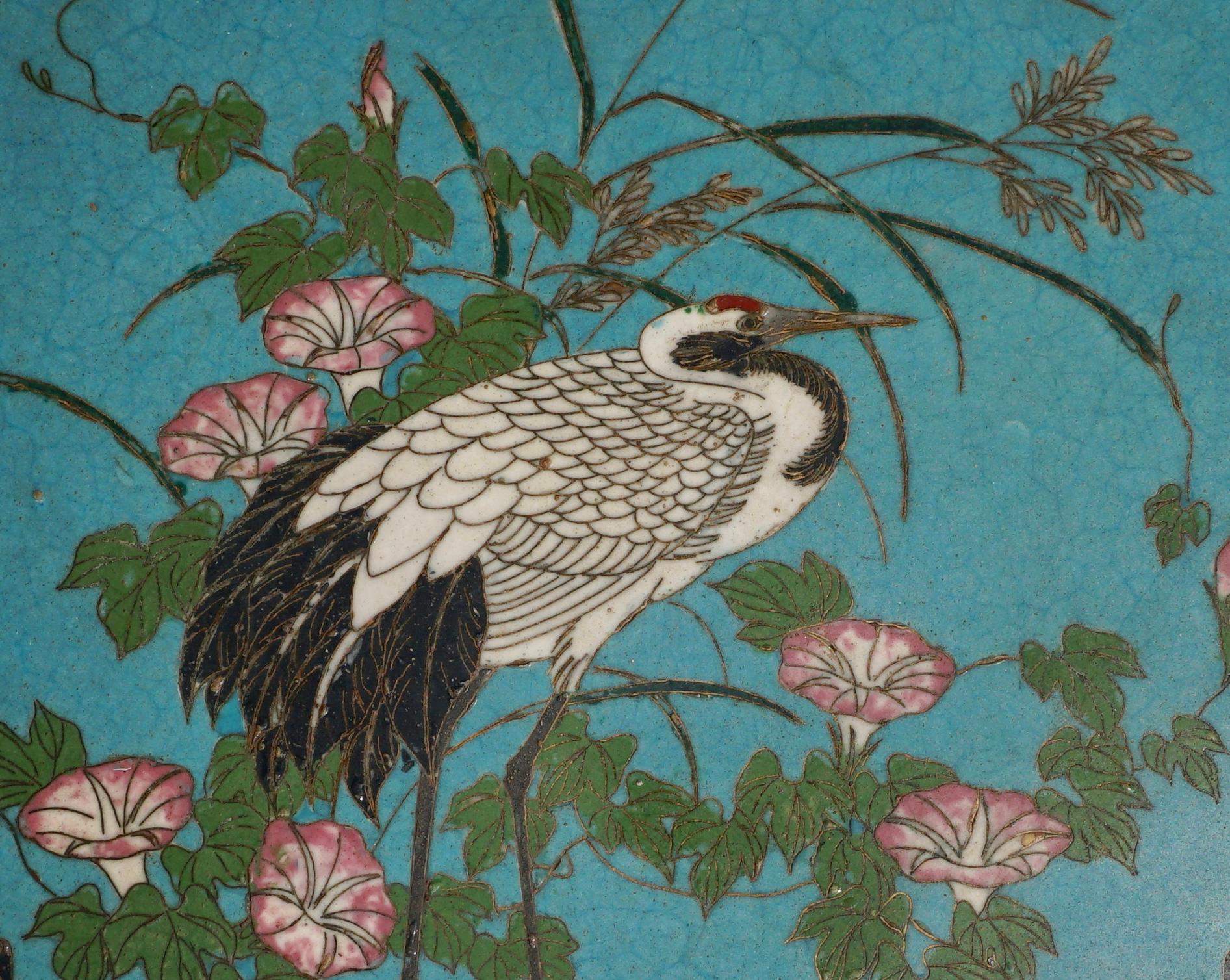 A early and exquisite Japanese Cloisonne platter in rare imperial blue background to frame a beautiful white crane amongst pink buttercups, vines and foliage. Vary auspicious with a detailed pattern around the borders. 

Measures: Diameter 9.75