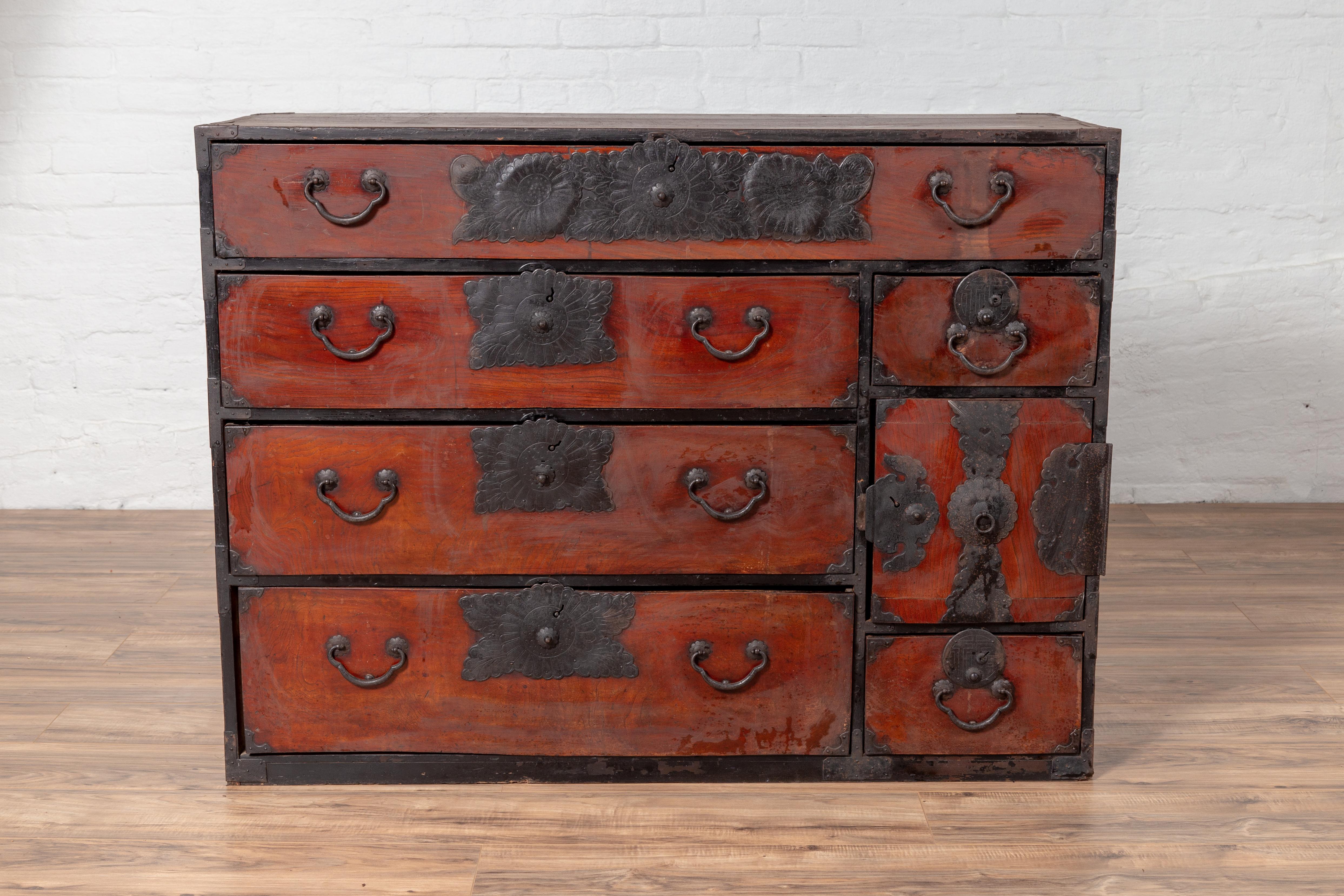 A Japanese Meiji period tansu clothing chest in the Sendai Isho-dansu style, made of Keyaki wood with hand-cut iron hardware. Born during the 19th century, this keyaki (elm) wood tansu is a fine example of Japan's traditional mobile cabinetry.