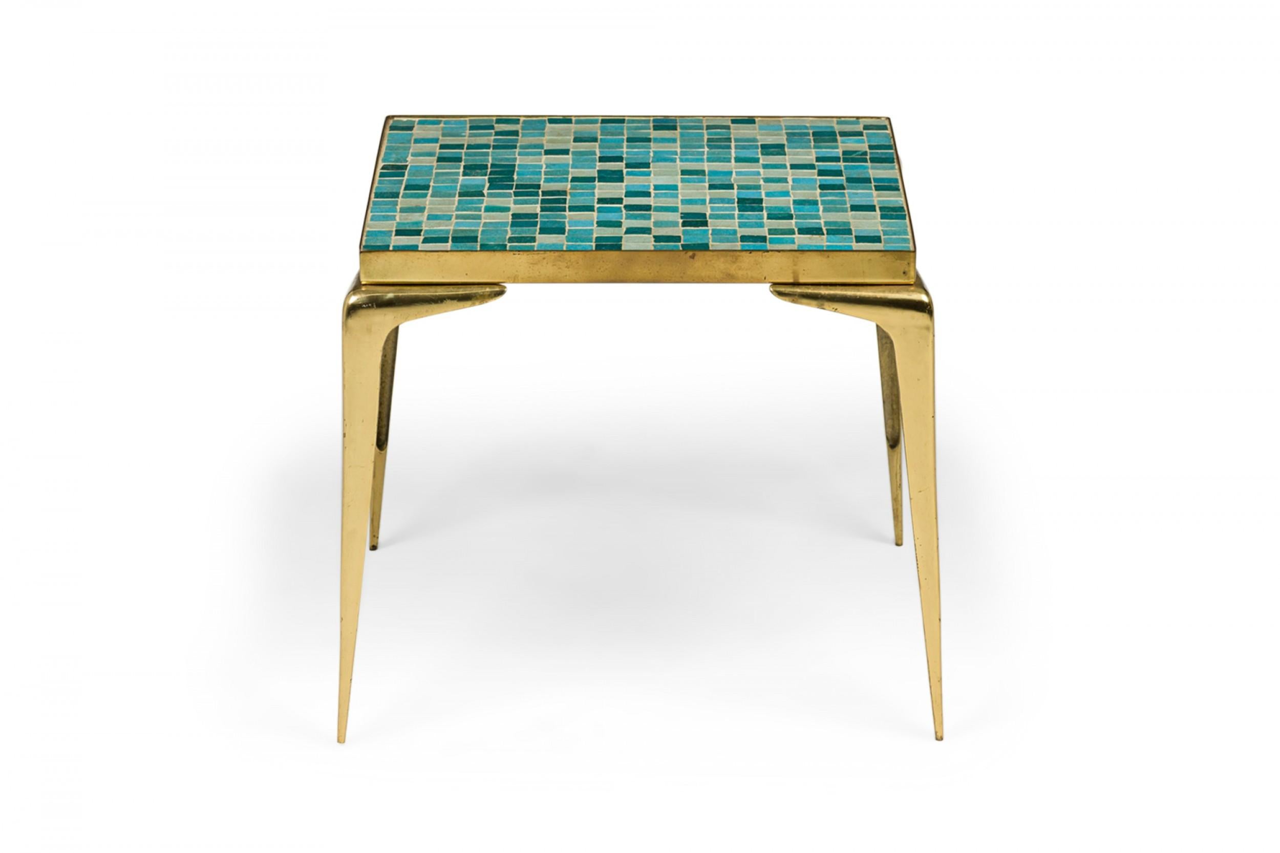 Japanese mid-century end / side table with a Murano glass tiled top in varied shades of blue and gray, resting on a shaped brass frame with four tapered legs.
 