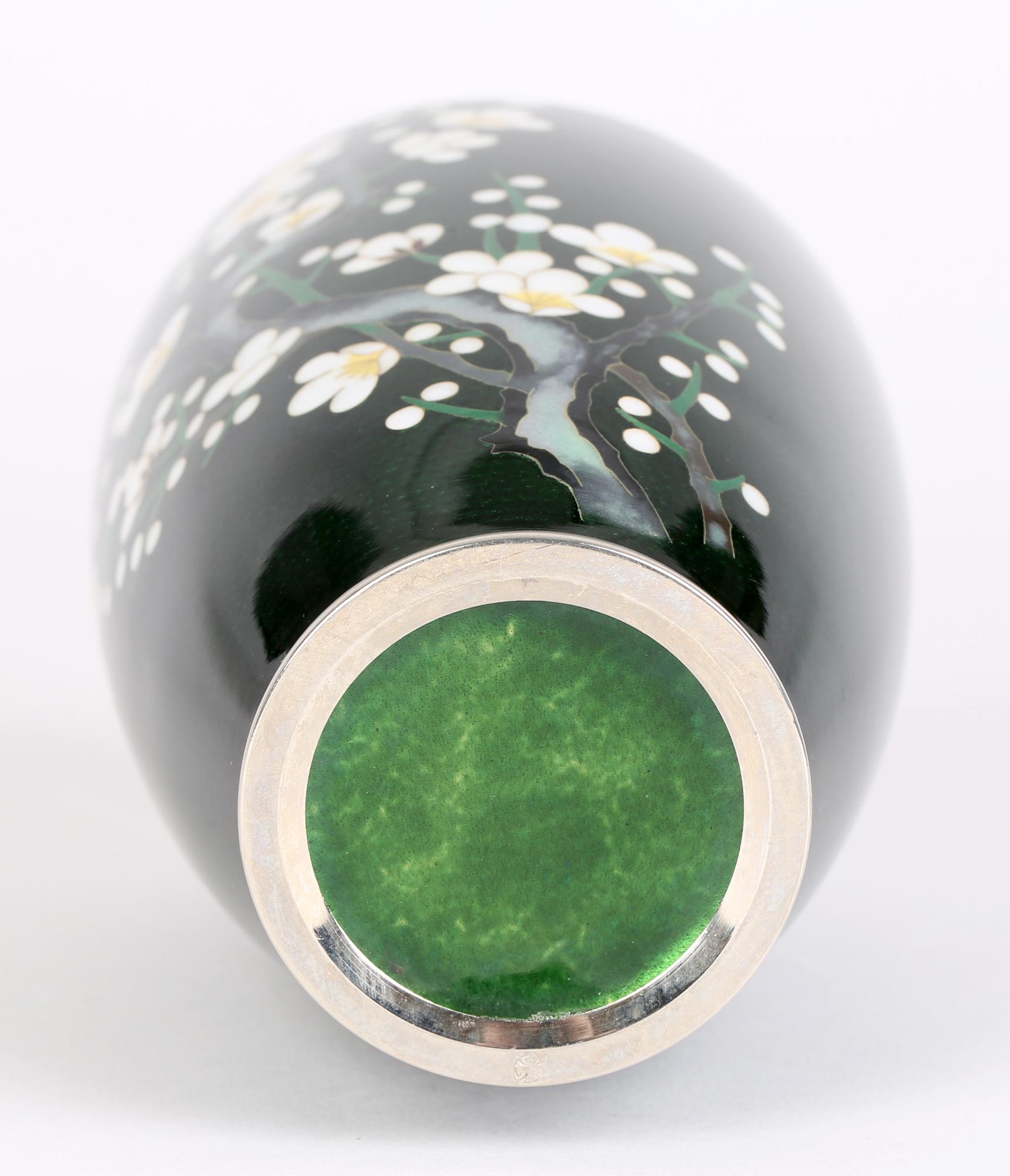 A very fine mid-century Japanese Silver metal cloisonne vase decorated with flowering Hawthorn and dating from around 1950. This elegant bulbous shaped vase is finely made with silver rim to the foot and top and with a flowering hawthorn tree with