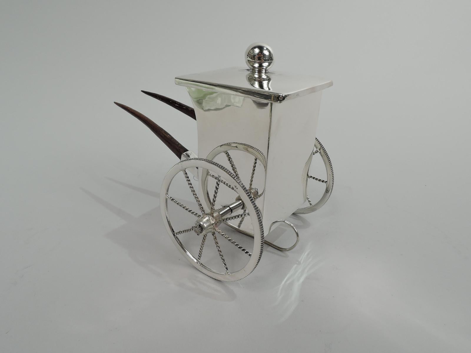 Japanese Mid-Century Modern sterling silver pushcart cigarette cup. Rectilinear with stained-wood handles. Cover hinged with ball finial for keeping tobacco products fresh and dry. Wheels have ribbed tread and twisted spokes, and they rotate. A