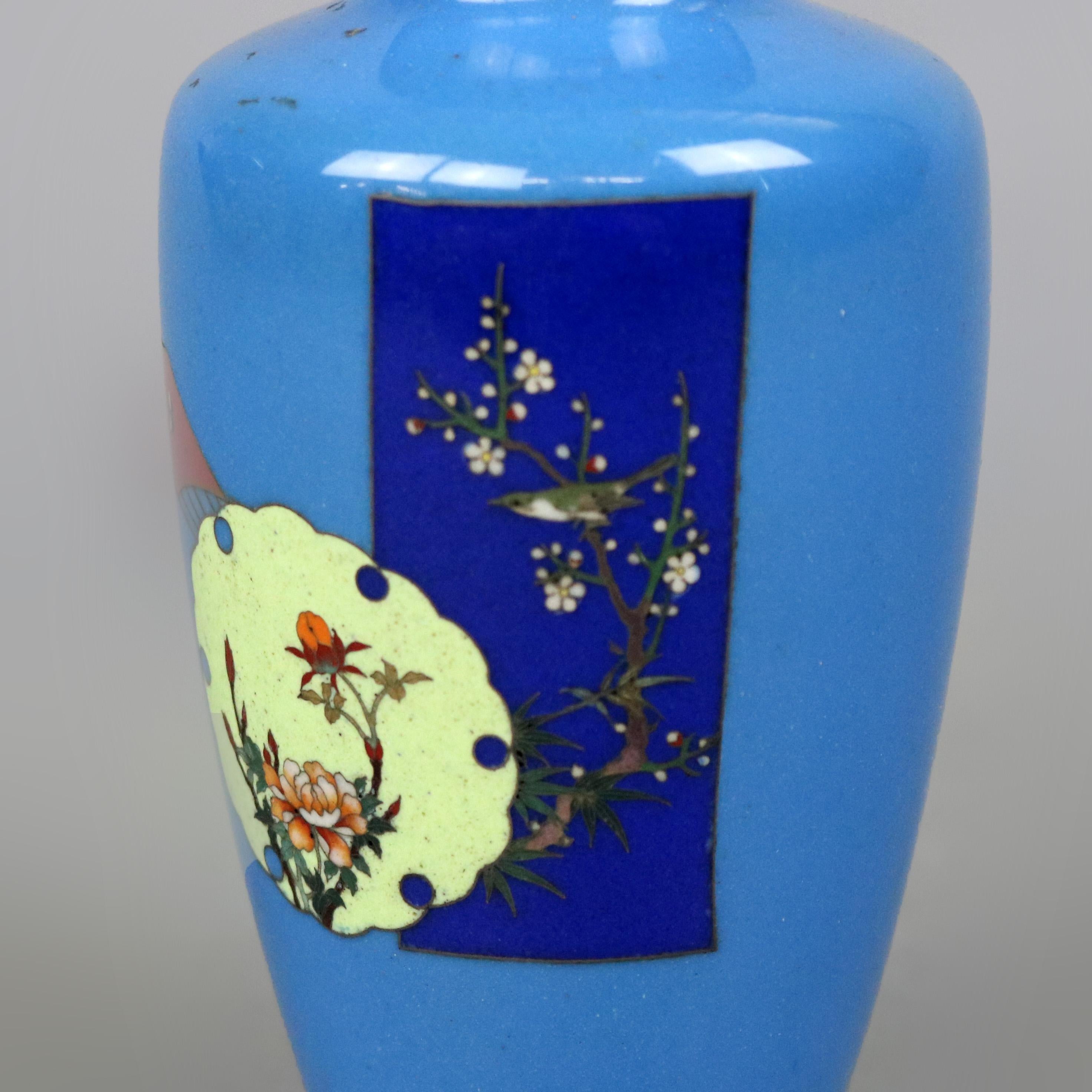 An antique Japanese aesthetic movement cabinet vase offers cloisonné enamel decoration with floral reserves, one having cherry blossom and bird, en verso crescent moon, circa 1870

Measures: 4.75