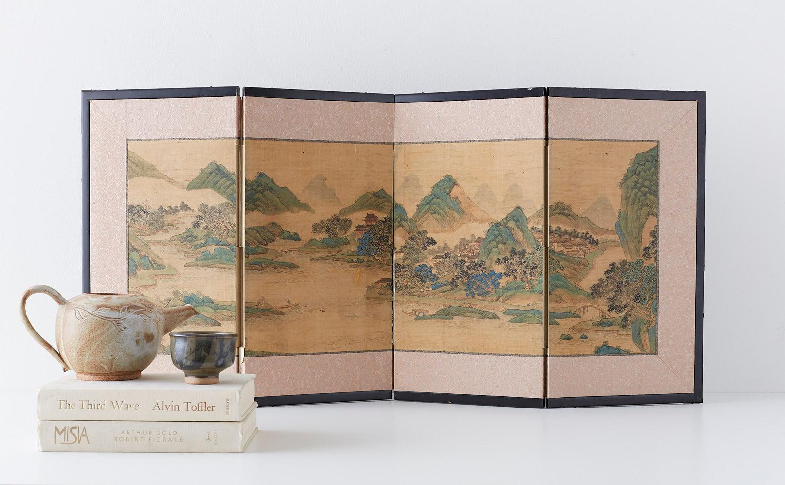 19th century mid-Edo period Japanese four-panel miniature screen. Depicting a beautifully painted Chinese blue and green landscape in the Nanga School or literati painting style. Ink and color pigments on silk mounted in a lacquered wood frame with
