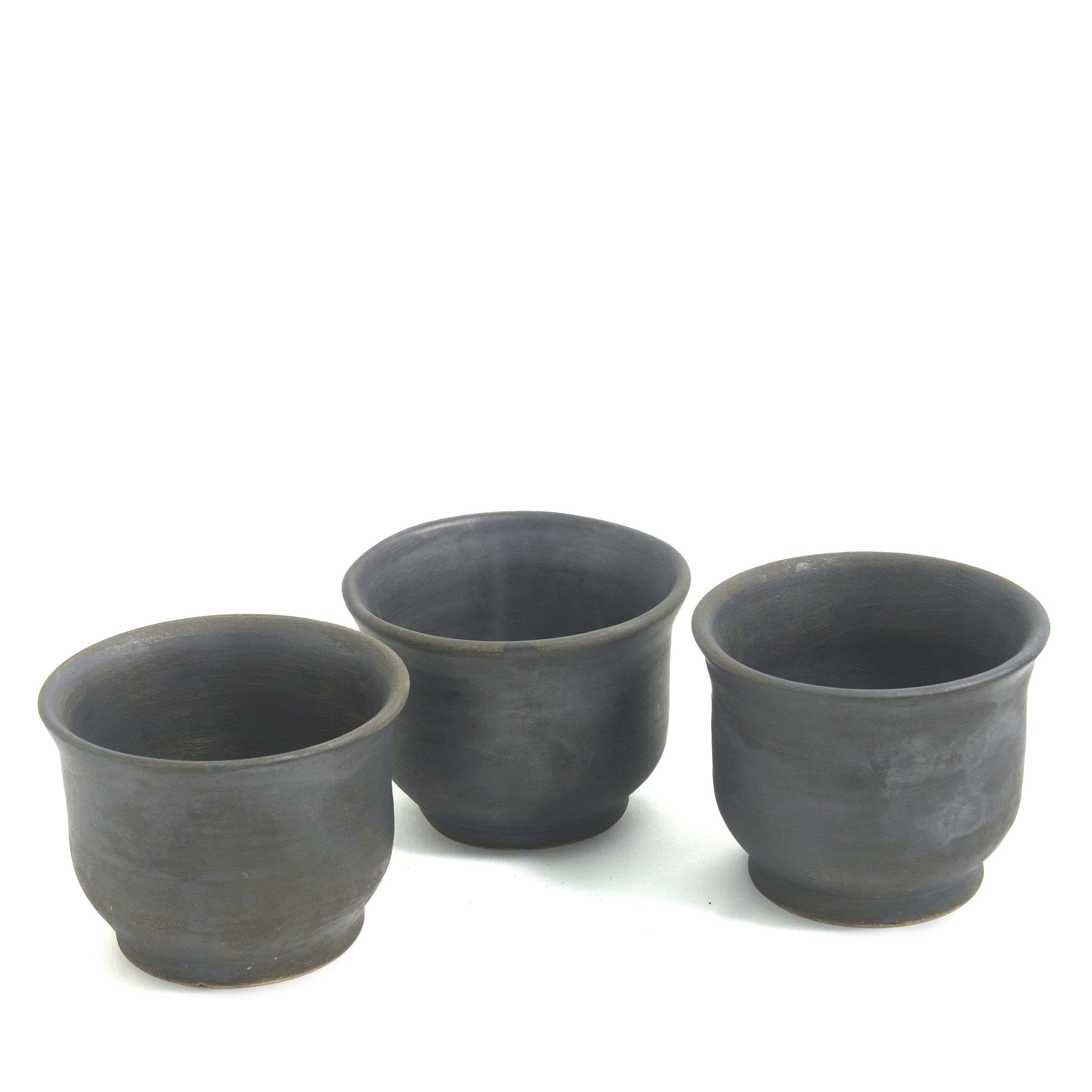 Terre 3 tasses

Ce lot de trois tasses en céramique noire mate, habilement fabriquées à la main sur un tour, constitue un ajout exclusif aux collections de vaisselle moderne, qu'il agrémente d'un soupçon de style oriental. Les pièces sont