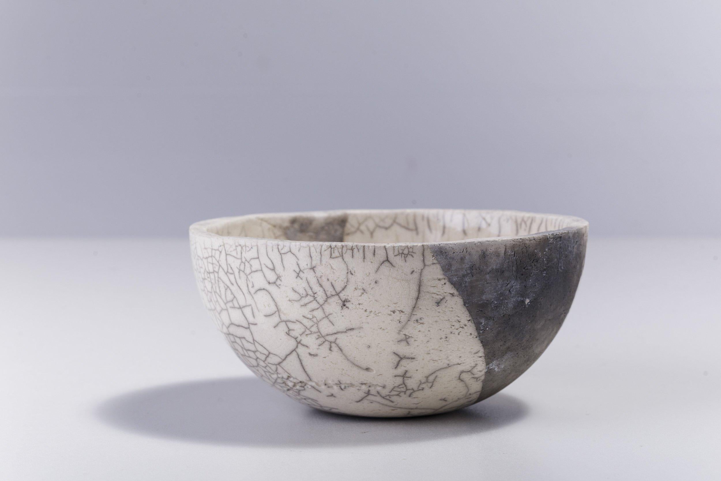 Fringe chawan bowl

Irregular, dramatic gray cracks of bold visual impact embellish the polished ceramic surface of this spectacular chawan bowl, handcrafted following the ancient Japanese technique of Raku. A perfect complement to any decor, it