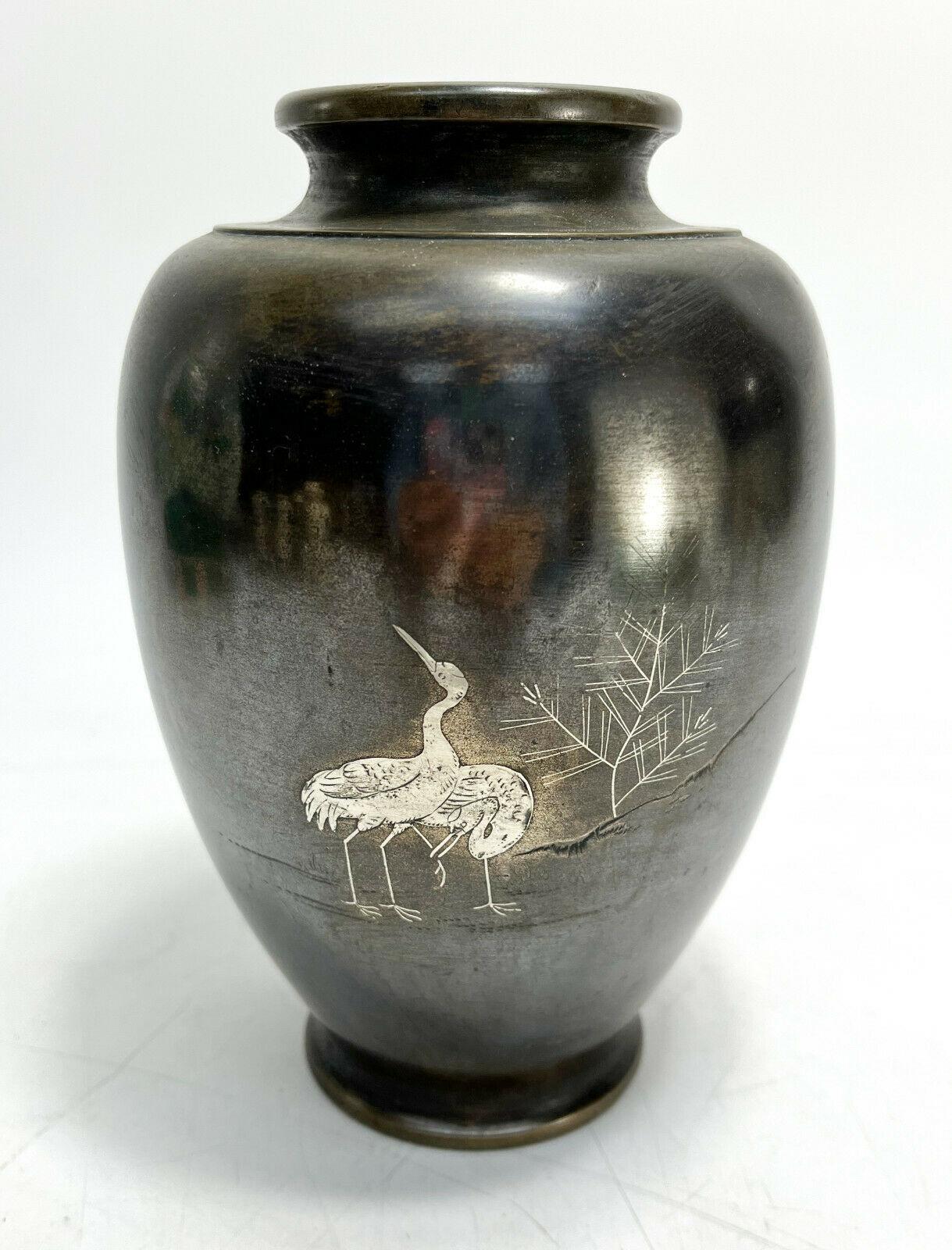 Japanese mixed metal bronze and silver vase, storks, likely Meiji Period.

The central area depicts silver inlaid storks next to a leafless tree. With extensive Japanese maker hallmarks to the underside base. Likely from Japan's Meiji Period