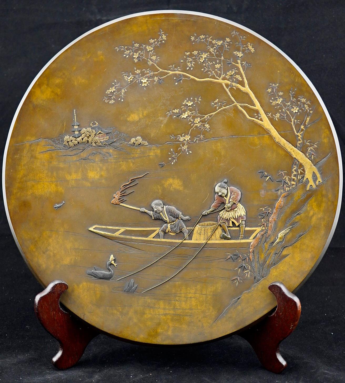 Japanese mixed metal platter finely executed to show night fishing with cormorants.
Unsigned.