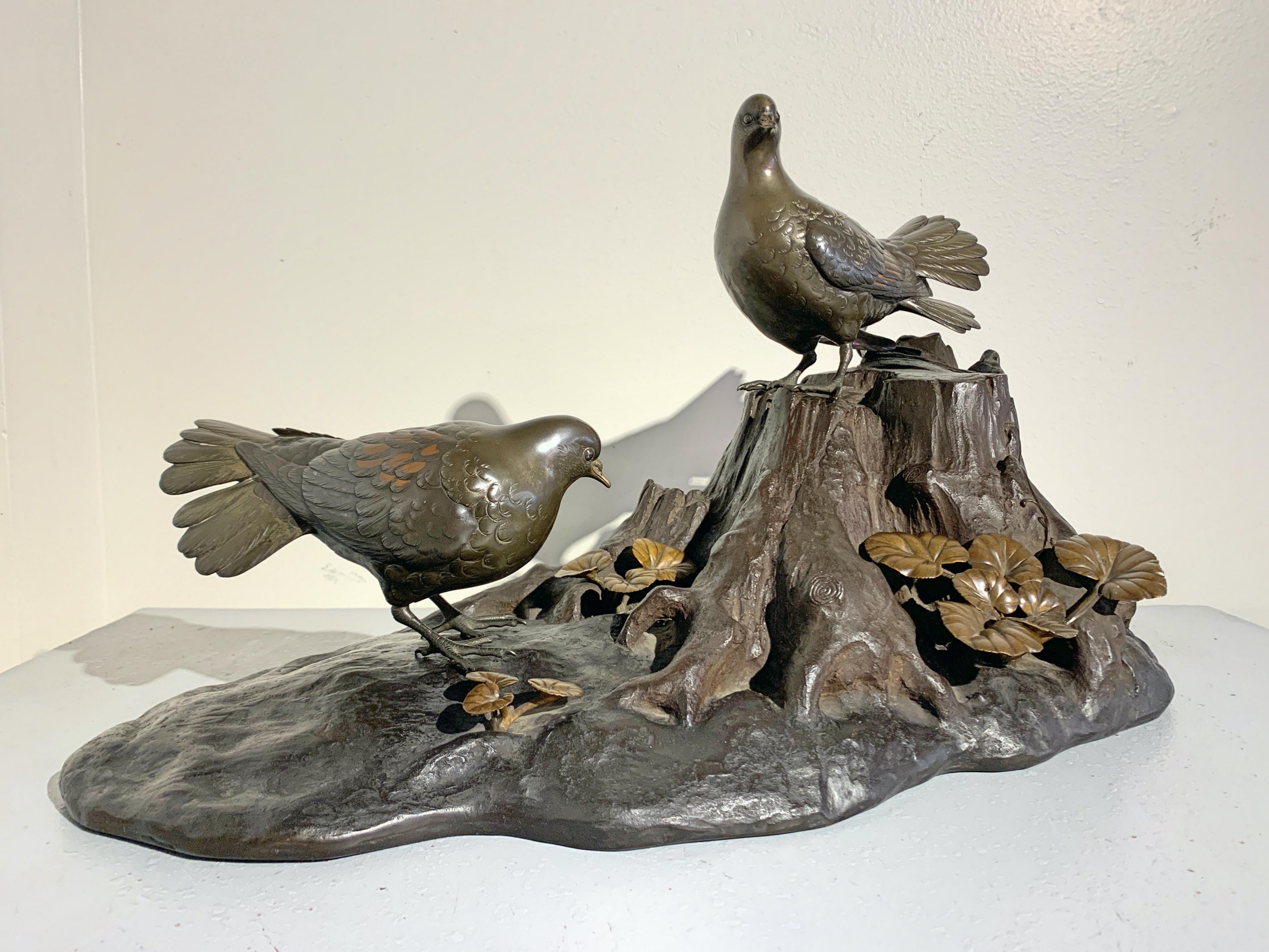 A wonderfully naturalistic large Japanese Meiji period mixed metal okimono (ornamental sculpture) of a pair of oriental turtle doves perched on a gnarled tree trunk, signed Seifu, late 19th century, Japan. 

The detachable pigeons masterfully cast