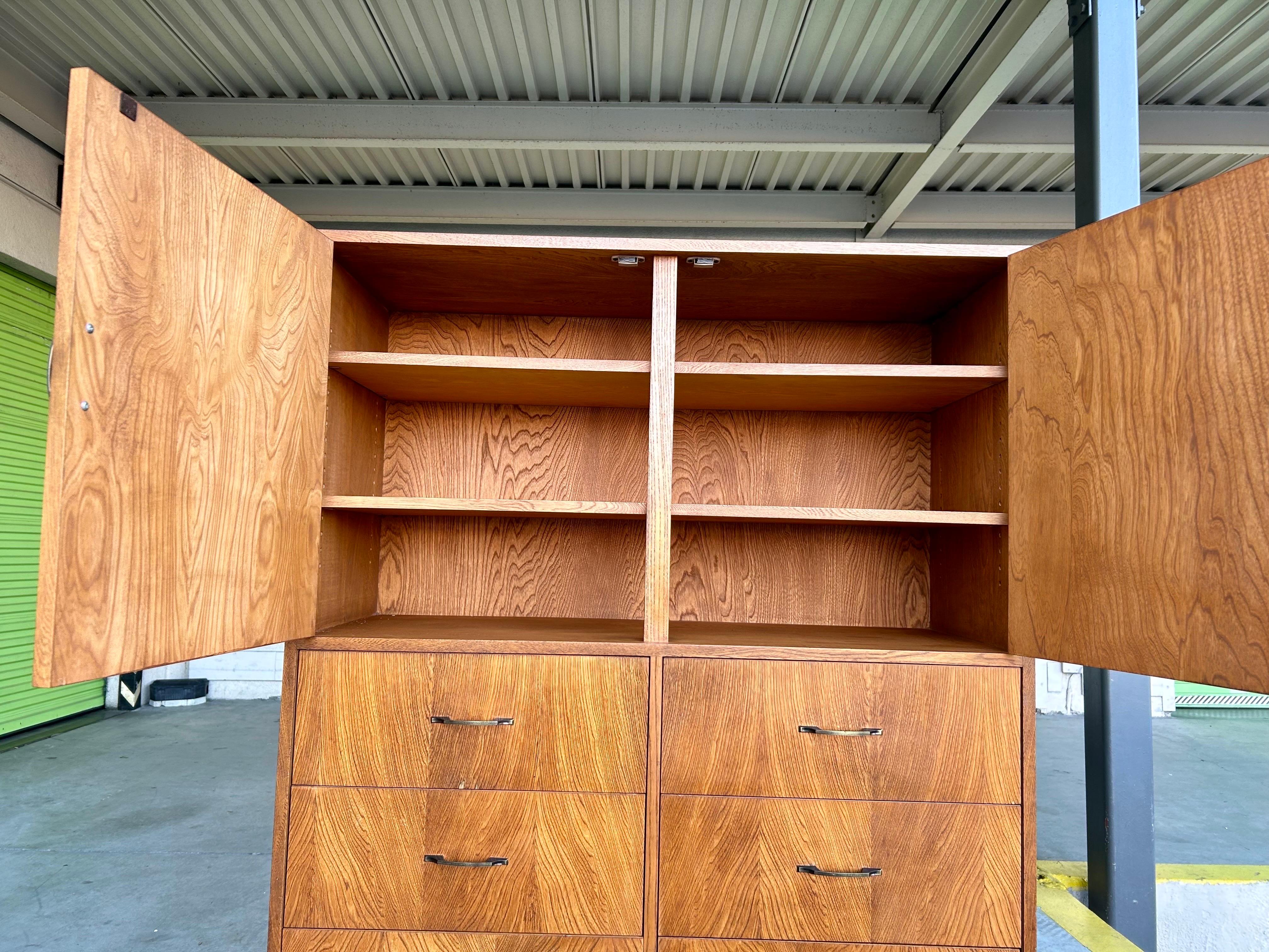Rare and handsome dresser.
Danish modern style.
Simple and clean lines.
Architectural form and function.
Plywood (no pressboard) on solid wood base, nice grained keyaki wood veneer, decorative bronze pulls with masonite boards inside the drawers and