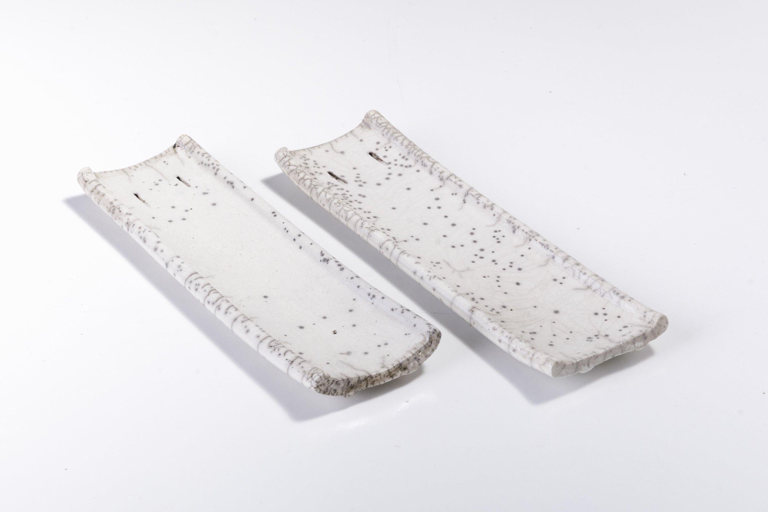 Incenso set

An extraordinary addition to a contemporary decor for a stunning visual allure, this set of two incense holders features a raw, porous shape deftly handcrafted following the Japanese technique of naked Raku ceramic firing. The two
