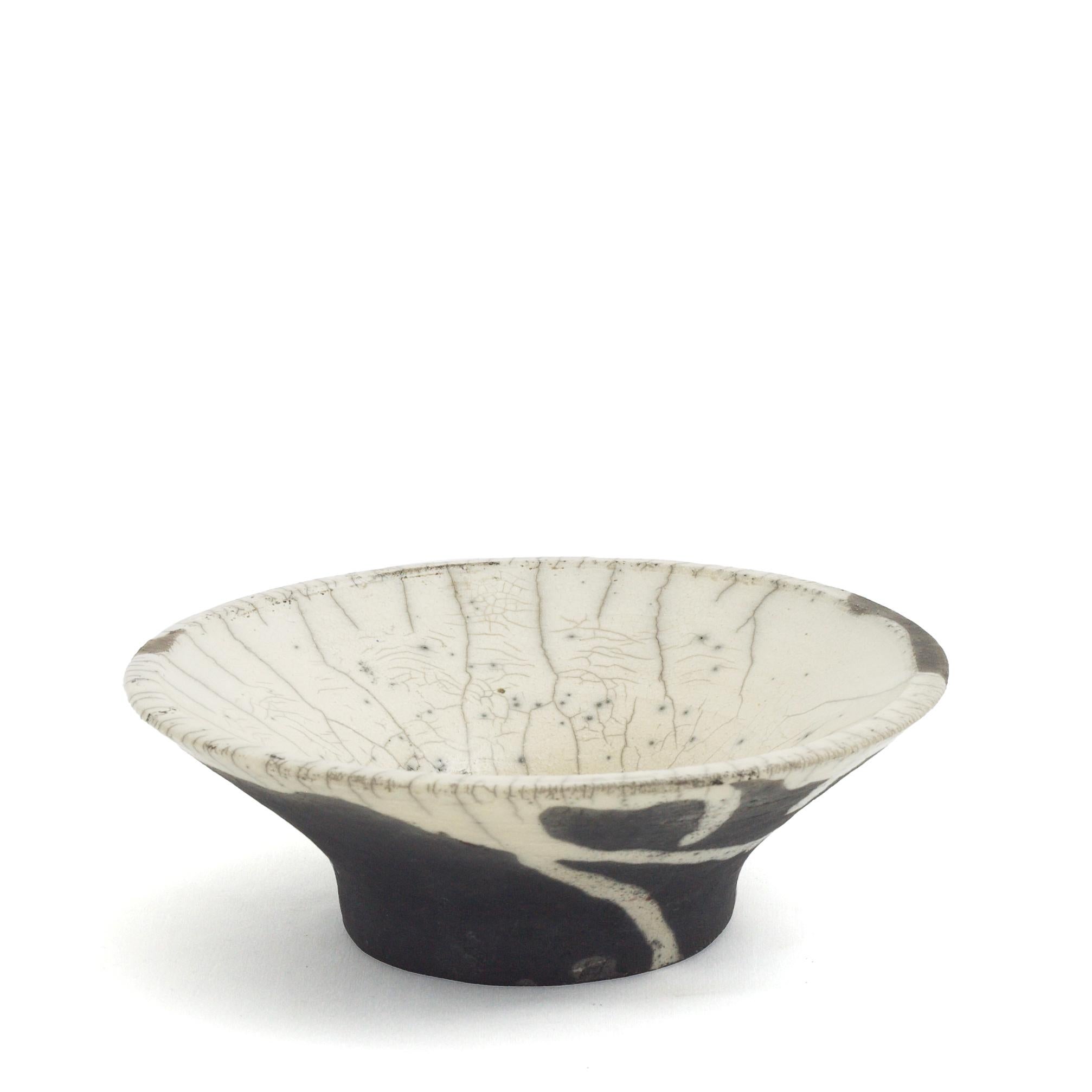 Cratere Vase

Named after the Italian for crater, the design of this handcrafted ceramic bowl flaunts a singular design of speckles and crackles. The white look on the interior - accented with crystalline - seemingly overflows on the external