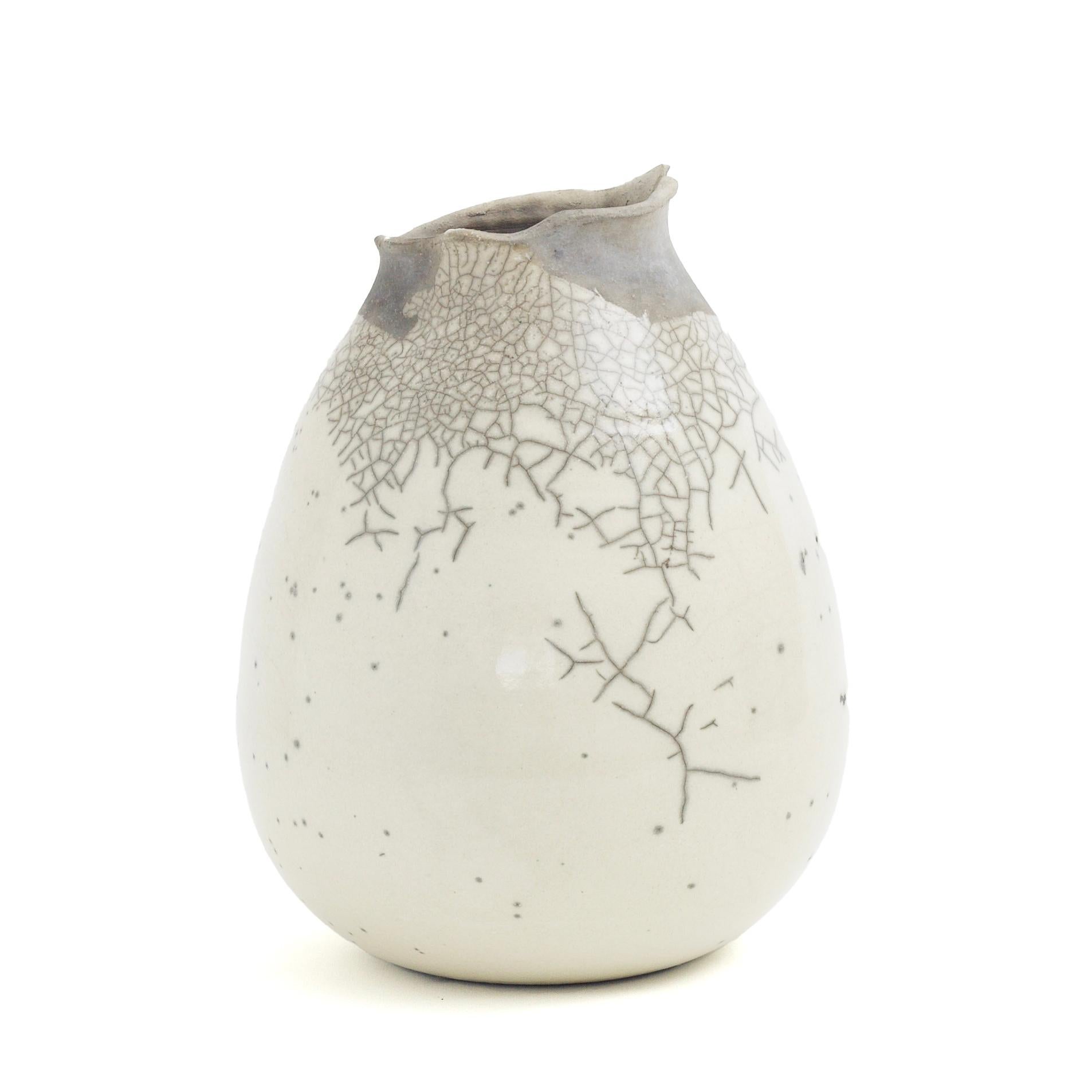 Impermanenza Grey

Defined by an unglazed finish and fluid, irregular aesthetic, this ceramic vase in gray and white will embellish any tabletop with its unique and sophisticated character. The singular crackles adorning the piece result from a