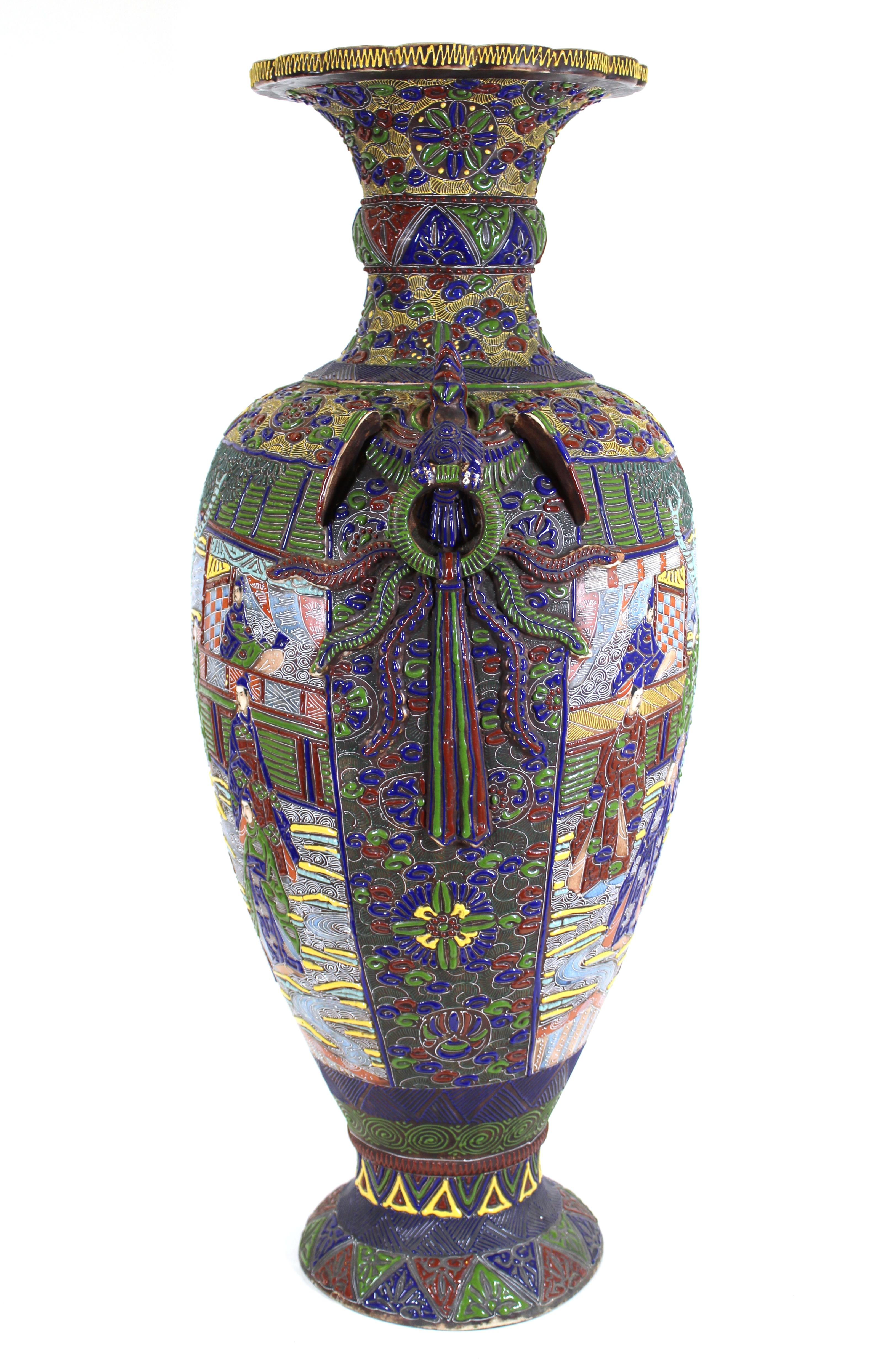 Japanese monumental Satsuma moriage raised enamel vase with vivid colors and intensive pattern work, depicting imperial court scenes on the front and back and phoenix bird shaped handles on the sides, marked on the bottom. Hand-made in Japan during