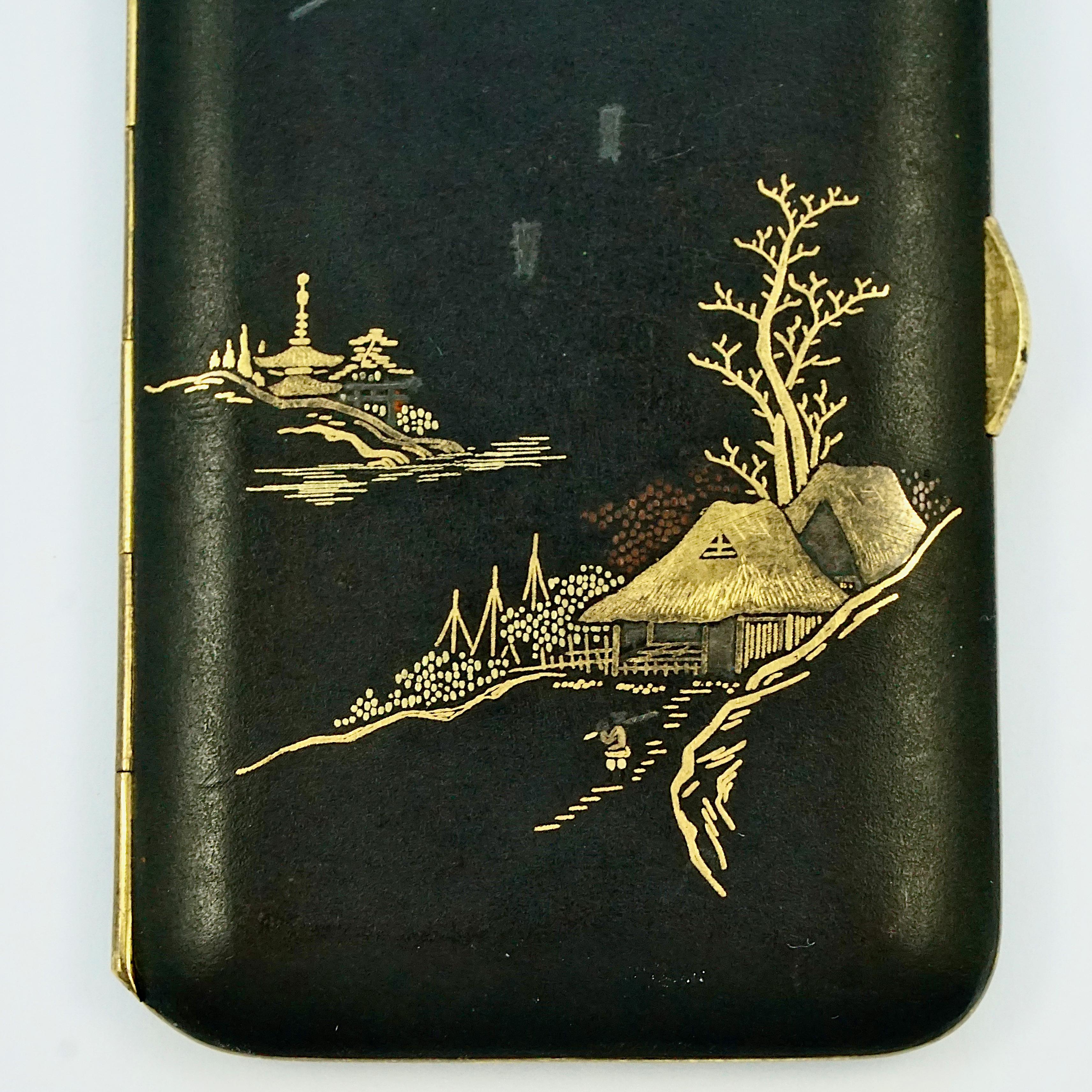 Exquisite Japanese damascene cigarette case with a Mount Fuji landscape, featuring 24K gold and silver decoration on a black background. Measuring length 8.7 cm / 3.4 inches by width 5.25 cm / 2 inches. We believe it is the artists signature on the