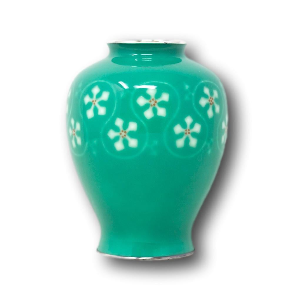 Japanese musen wireless cloisonne enamel vase early Showa period. The vase of globular form decorated in a mint green enamel with a band of abstract flowers in the form of geometric shapes around a looped boarder. The base signed to the centre with