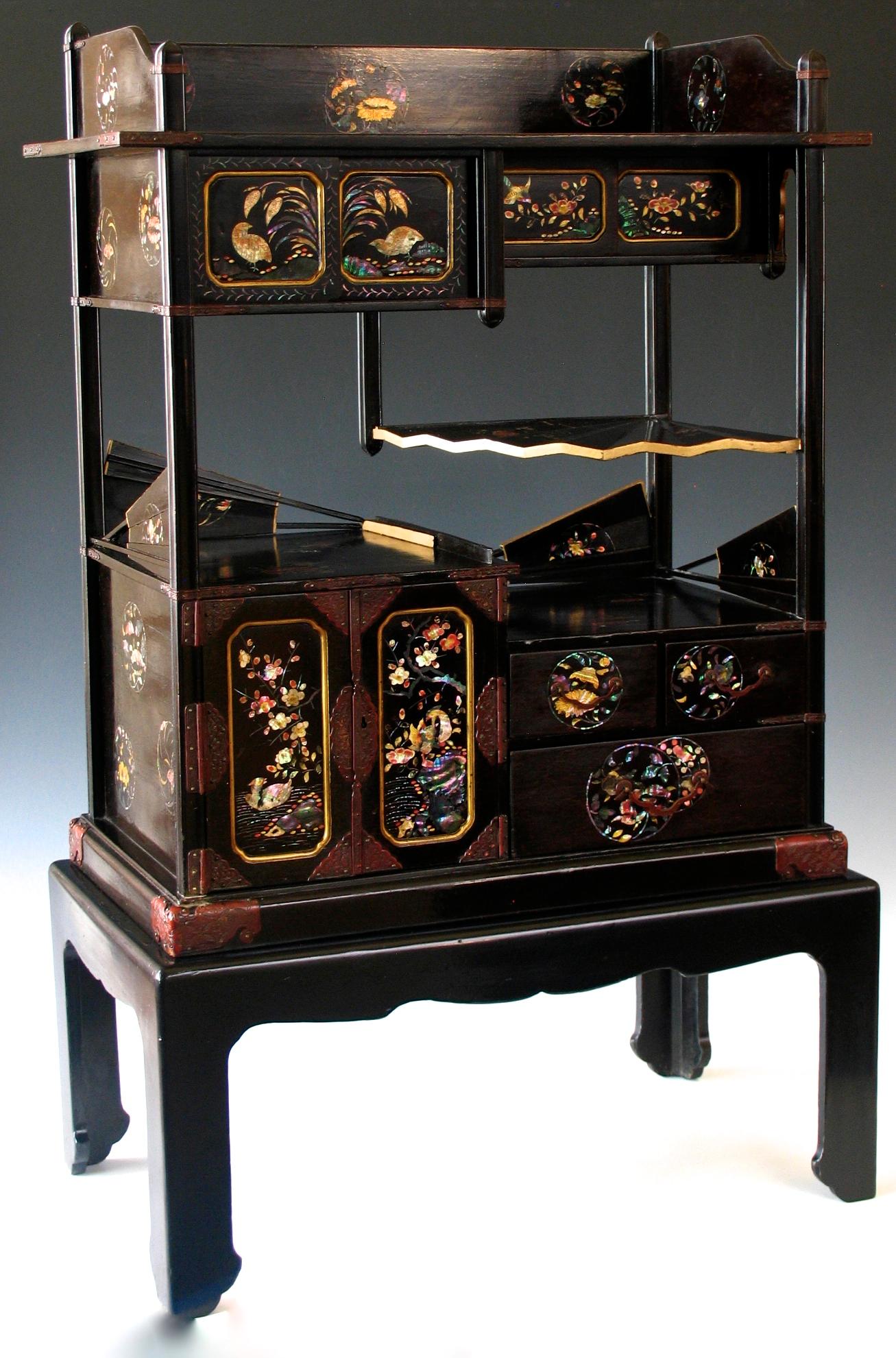 Japanese Nagasaki lacquer and colored mother of pearl inlaid display cabinet (Kazaridana) on a stand, possibly intended for export, with the charming design of folding fans as the railings and one open fan shape as a shelf, four shelf tiers in