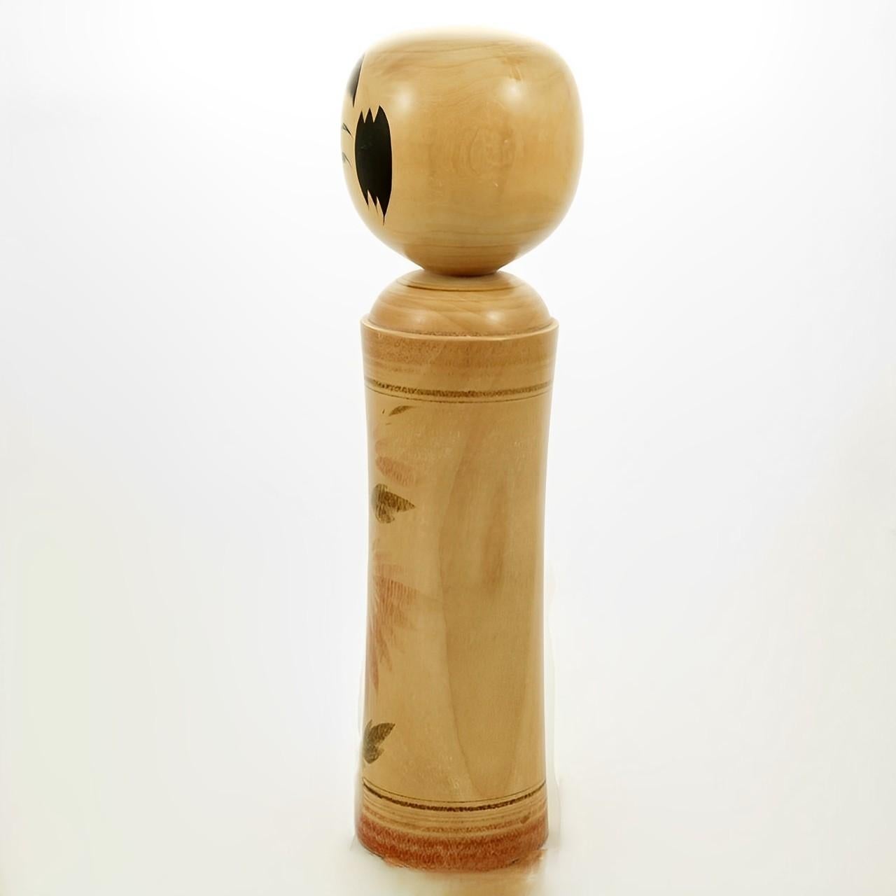 Japanese Kokeshi folk art wood doll by Kumagai Otsu. There are ten types of Kokeshi doll, this is the Naruko variety. Measuring height 23.5 cm / 9.25 inches by diameter at the base 5.7 cm / 2.24 inches. The Kokeshi doll is in very good condition,